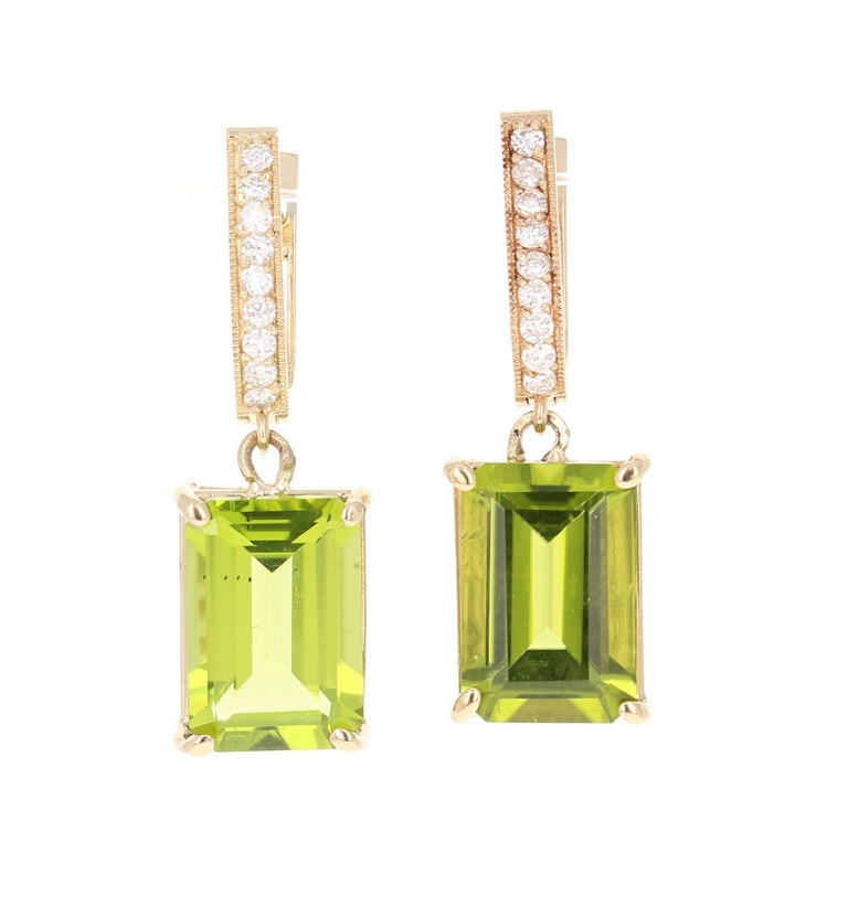 These lovely earrings have 2 Peridots that weigh 9.04 Carats and has 18 Round Cut Diamonds that weigh 0.27 Carats. The total carat weight of the earrings are 9.31 Carats. 

The diamonds have a clarity and color of SI2-F. 
The earrings are about 1
