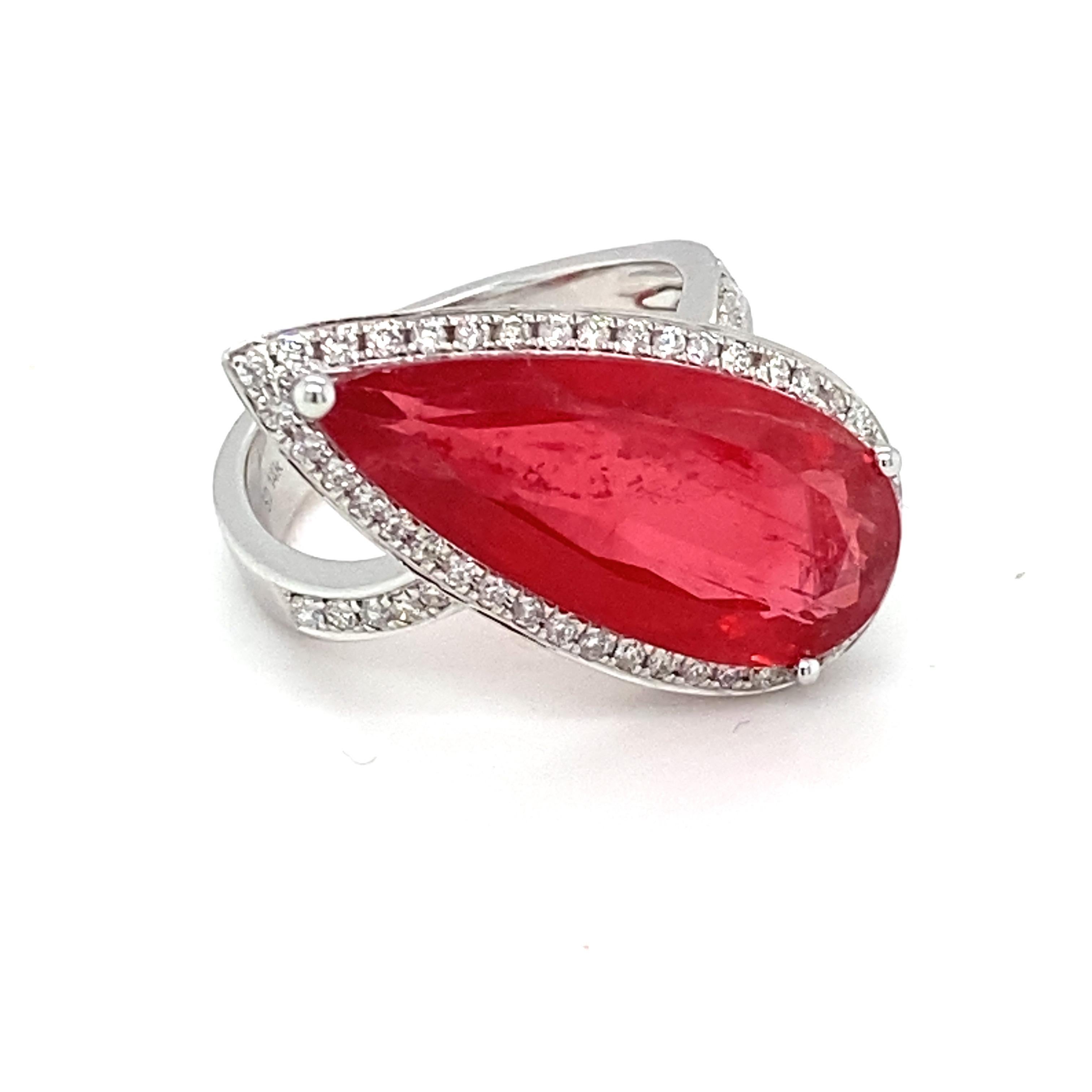 This 9.32 carat elongated pear rhodonite is set with three prongs framed by a halo of white diamond and has accents of diamonds on the band. This asymmetric design marries elegance and modernity. Hand finished by master craftsmen is one of a kind