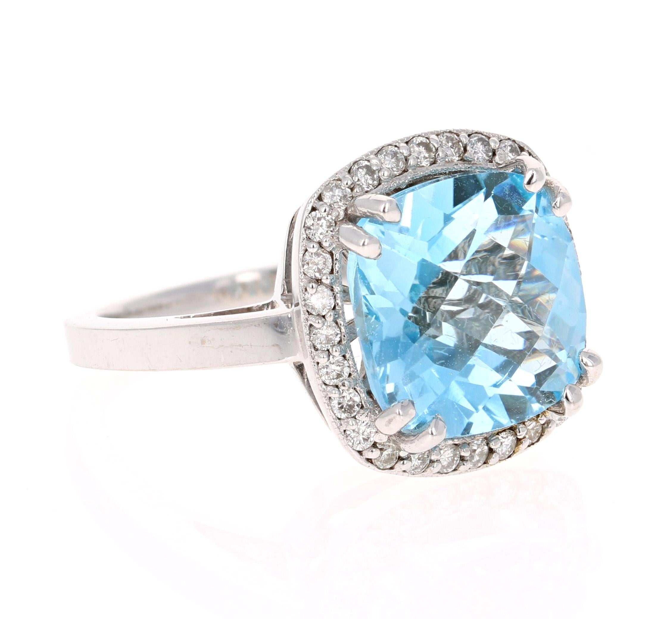 This incredible Square Cushion Cut Blue Topaz and Diamond ring has a stunning and large 8.94 Carat Blue Topaz and its surrounded by a halo of 28 Round Cut Diamonds that weigh 0.39 Carats. The total carat weight of the ring is 9.33 Carats. The