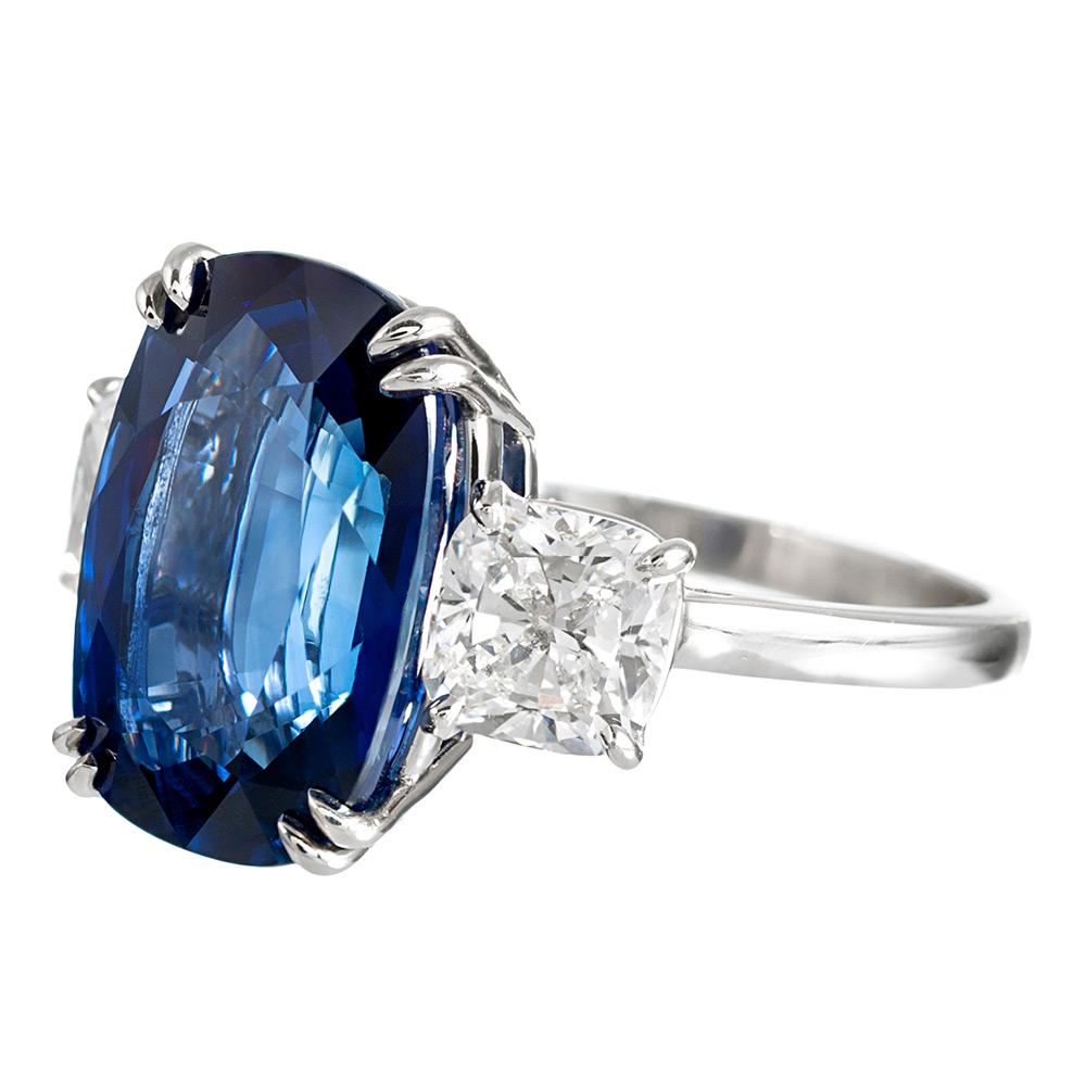 A classic setting has been created in platinum for this important stone. The sapphire is of Madagascar origin and weighs 9.33 carats. It is flanked by a pair of cushion diamonds that weigh 2.09 carats in total and grade as F color with Vs2 clarity.