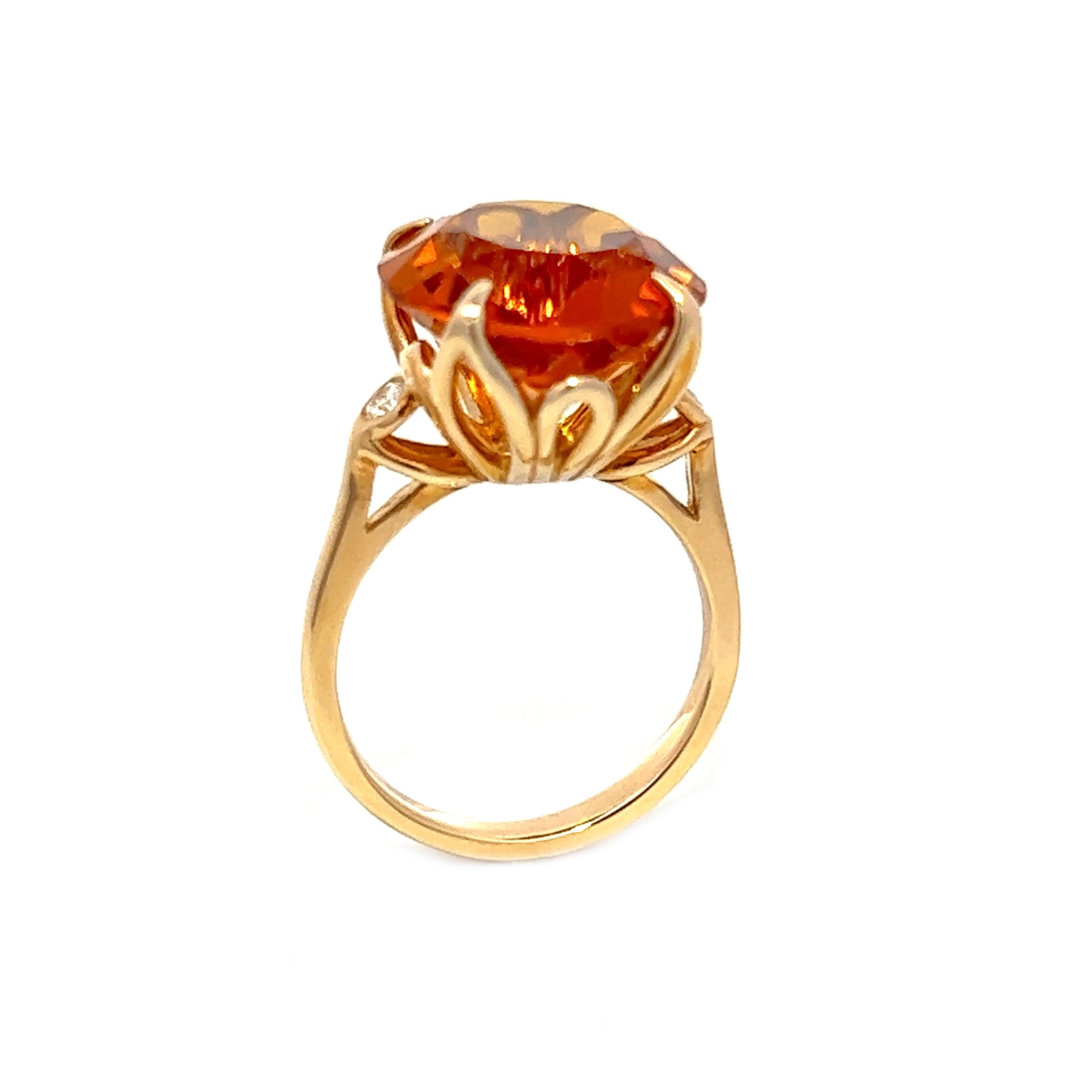 This 14K yellow gold ring is truly a one-of-a-kind piece, featuring a breathtaking 9.23CT orange topaz and two round brilliant diamonds totaling 0.10CT. The topaz is simply stunning and sure to turn heads.
