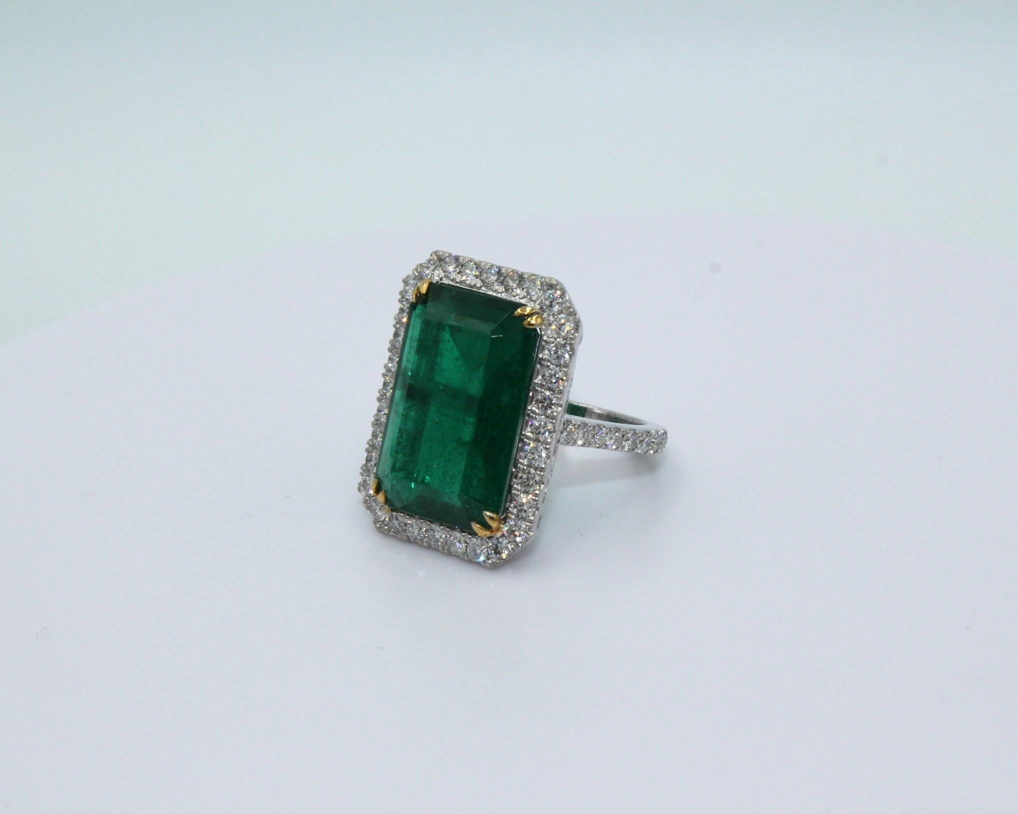 9.34 carats cushion shaped Zambian Emerald surrounded with 18 round shaped diamonds, totaling diamond weight of 1.57 carat. 

This gorgeous Emerald & Diamond Ring will highlight your elegance and uniqueness. 

Item Details:
- Type: Ring
- Metal: 18K