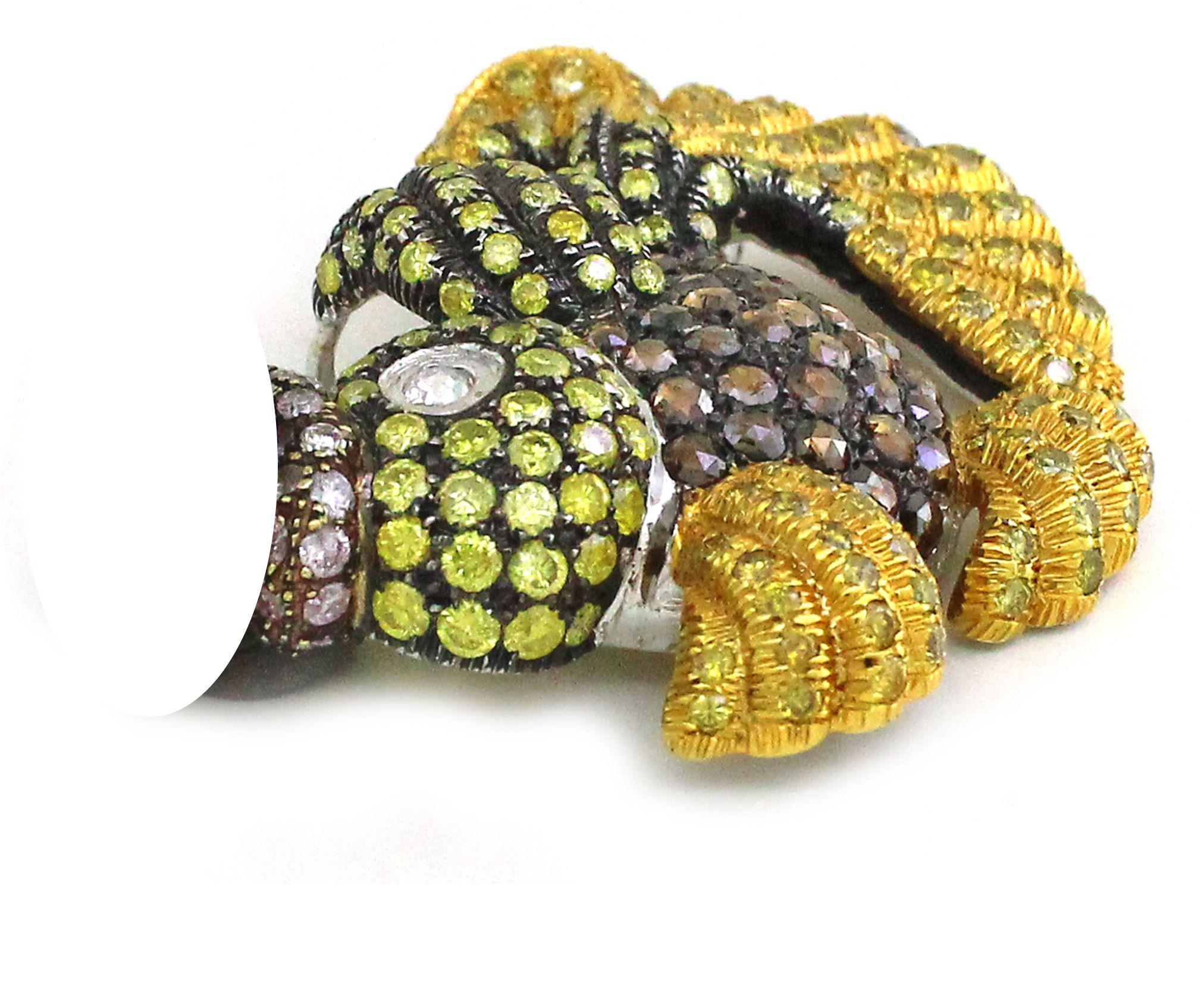 Immerse yourself in the allure of the ocean with this captivating fish-inspired brooch, a dazzling testament to the fusion of artistry and luxury. Crafted in 18K yellow gold, weighing 22.1 grams, this exquisite piece brings the underwater world to