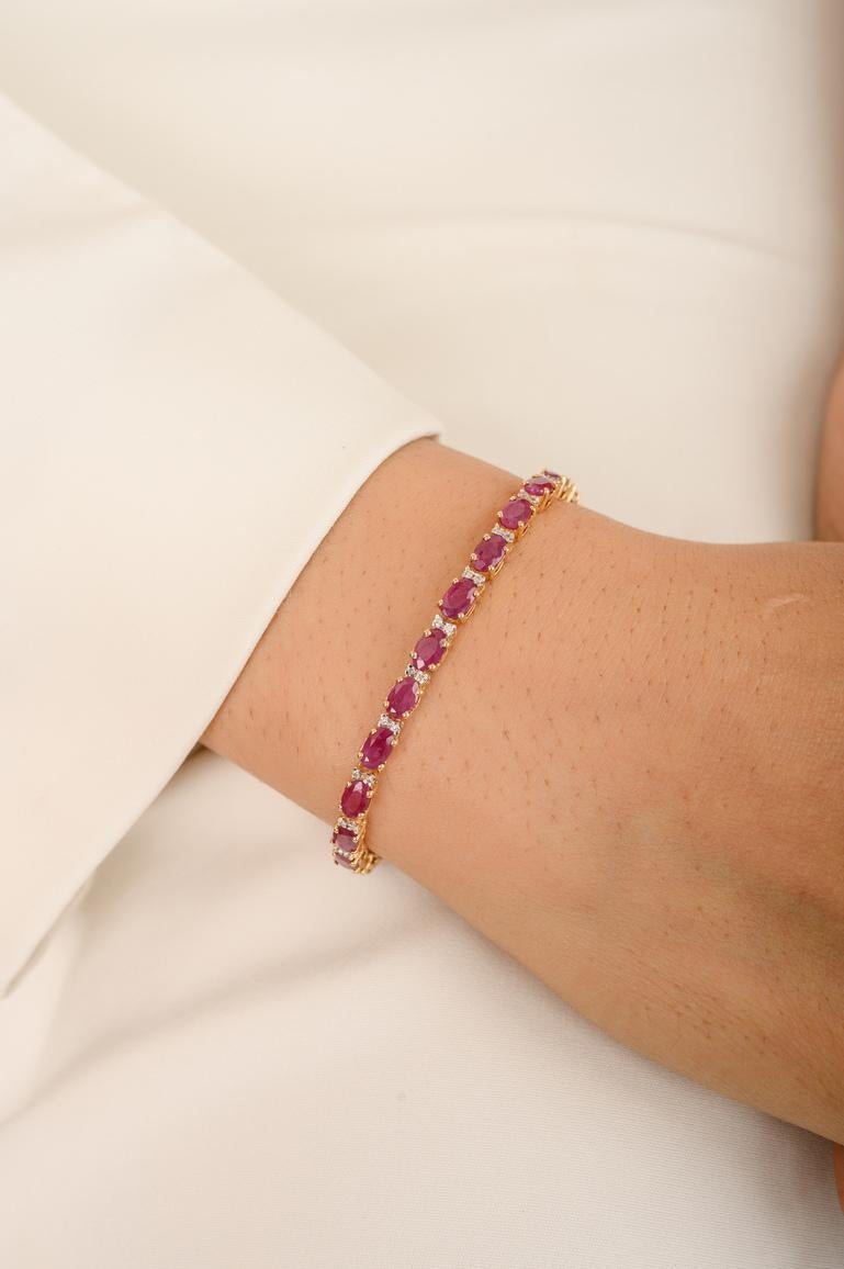 This Diamond Ruby Tennis Bracelet in 14K gold showcases 28 endlessly sparkling natural ruby, weighing 9.36 carat. It measures 7 inches long in length. 
Ruby improves mental health. 
Designed with perfect oval cut ruby with two diamonds in between
