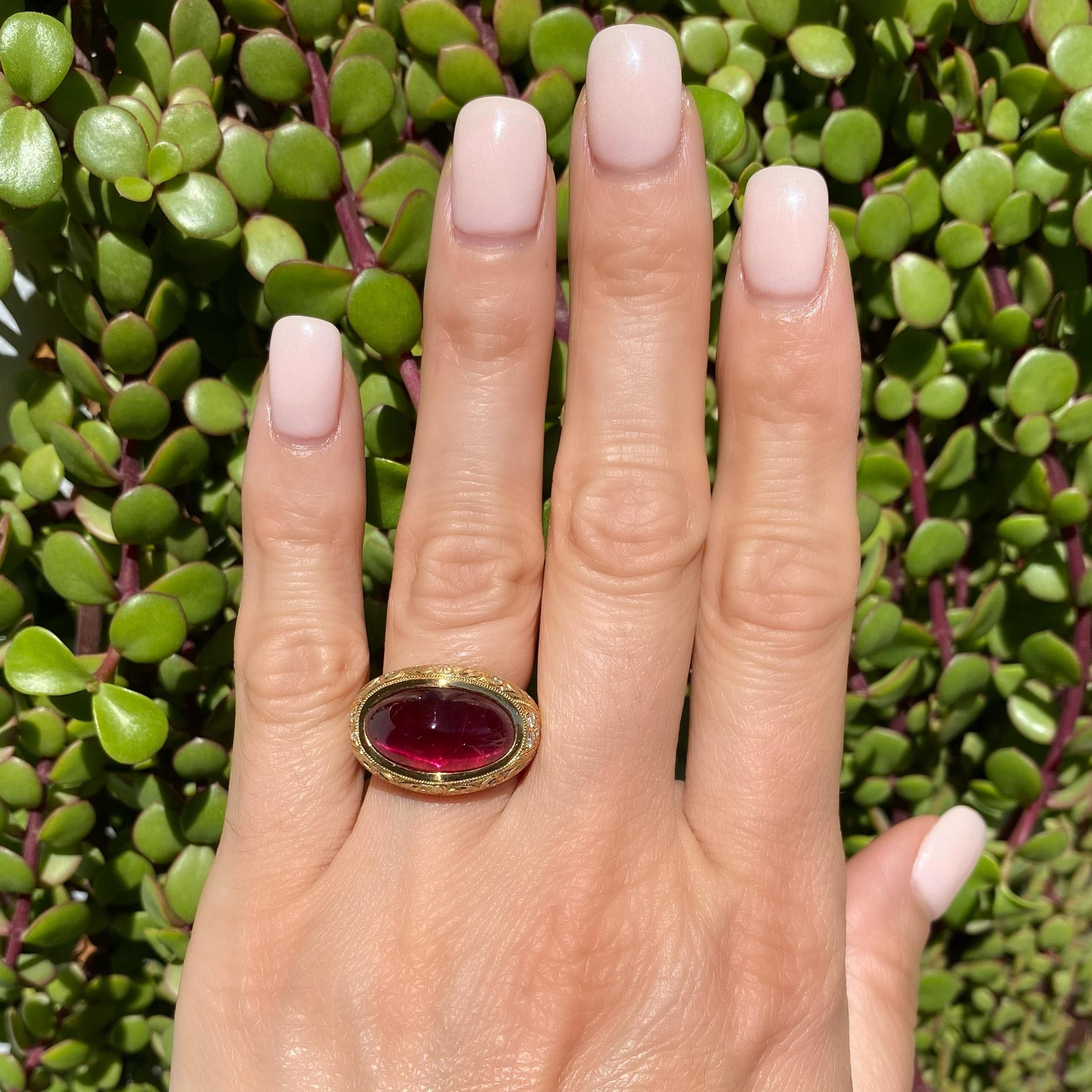 Awesome Sugarloaf Rubelite Tourmaline and Diamond Ring. Center securely nestled and Hand set with an oval 9.39 Carat Sugarloaf Rubelite Tourmaline, accented by Diamonds, approx. 0.25tcw. Beautifully Hand engraved and Hand crafted 18K Yellow Gold