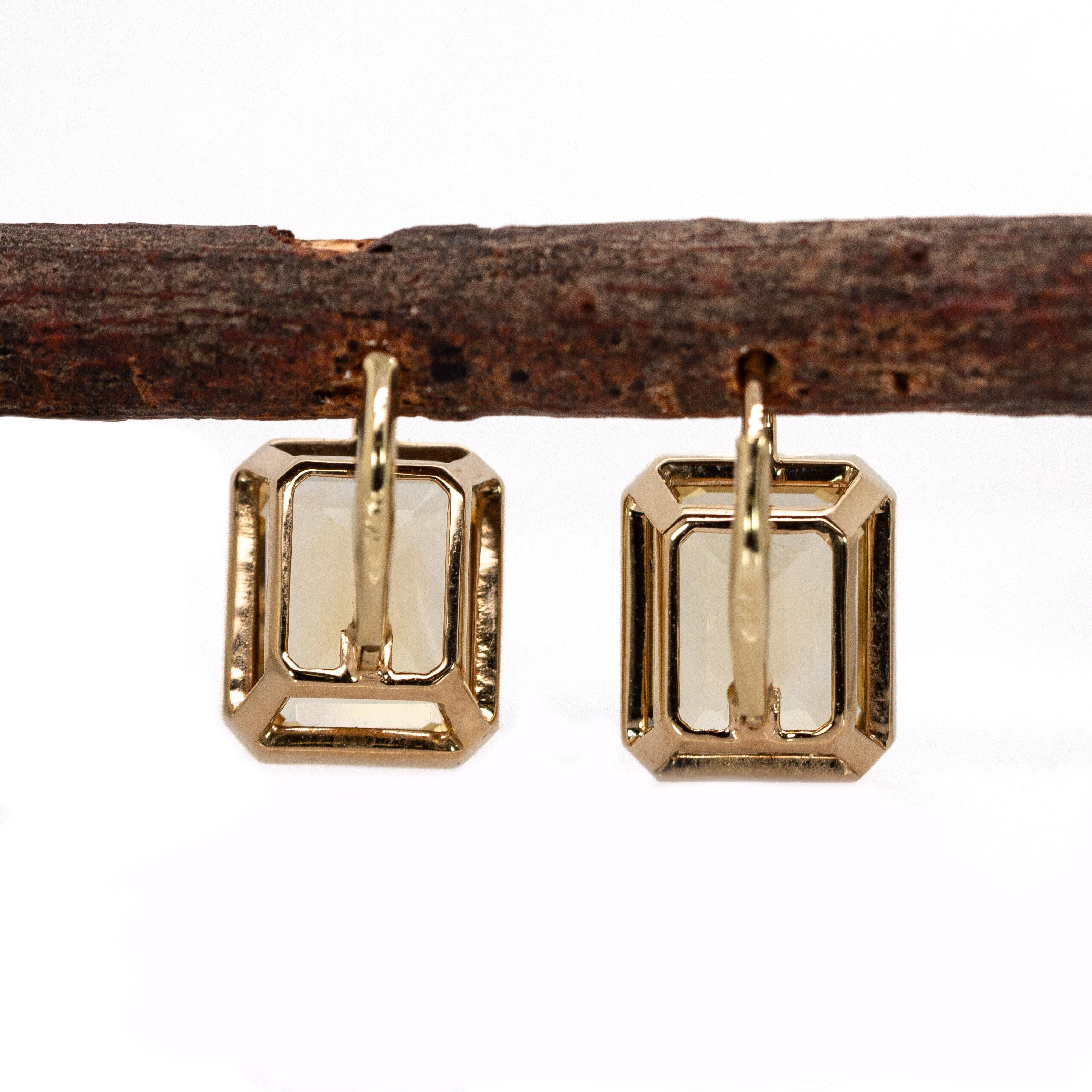 These radiant earrings showcase two emerald-cut Citrine gemstones totaling 9.26cts, each measuring 11x9mm. Set in 3.46g of 14k gold with secure lever back closures, their warm golden hue brings a touch of bold elegance ,perfect for adding a vibrant