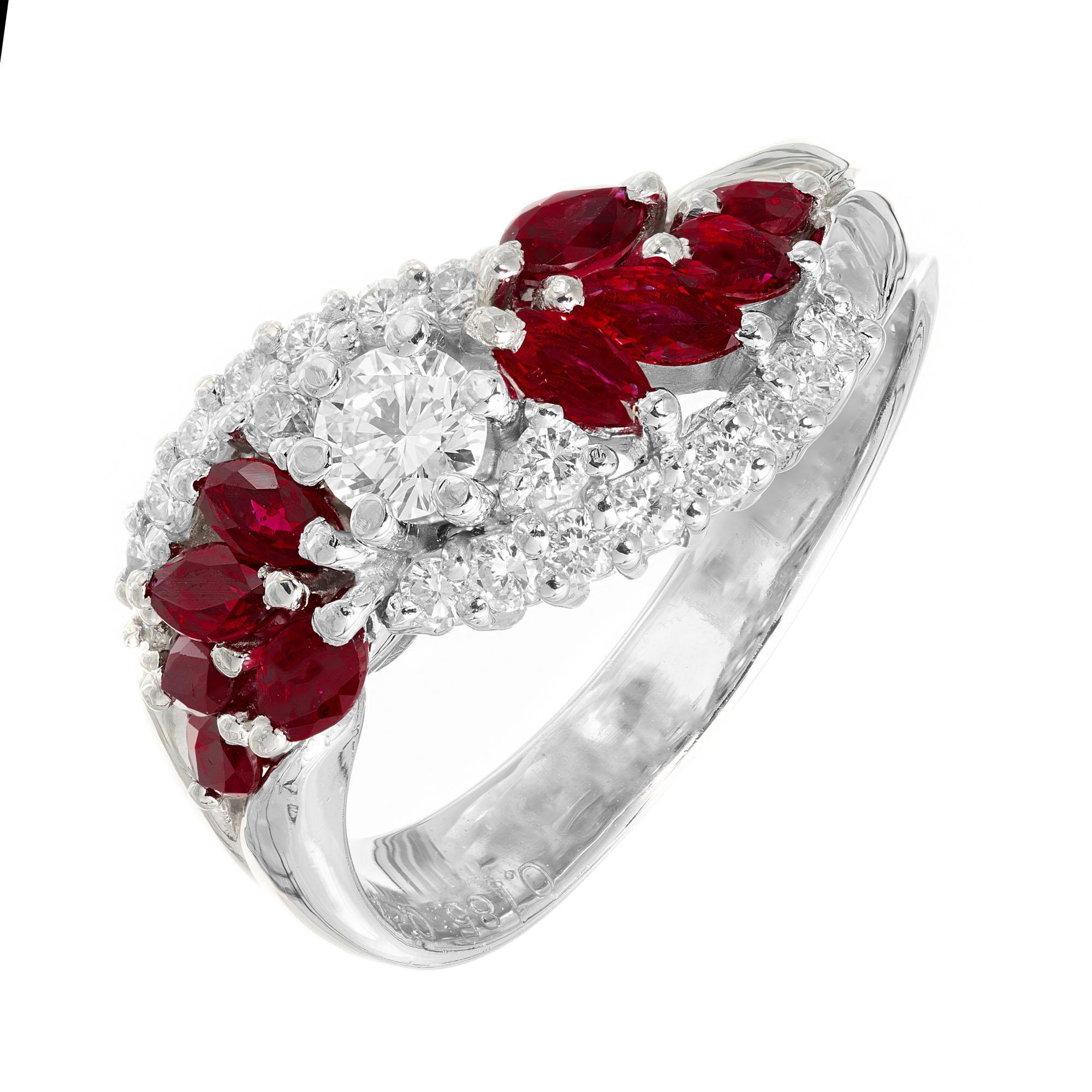 Ruby and diamond band ring. .18ct round brilliant cut center diamonds with 10 marquise cut rubies and 18 round brilliant cut diamonds in a swirl cluster setting.  

1 round brilliant cut diamonds, I-J SI approx. .18cts
18 round brilliant cut