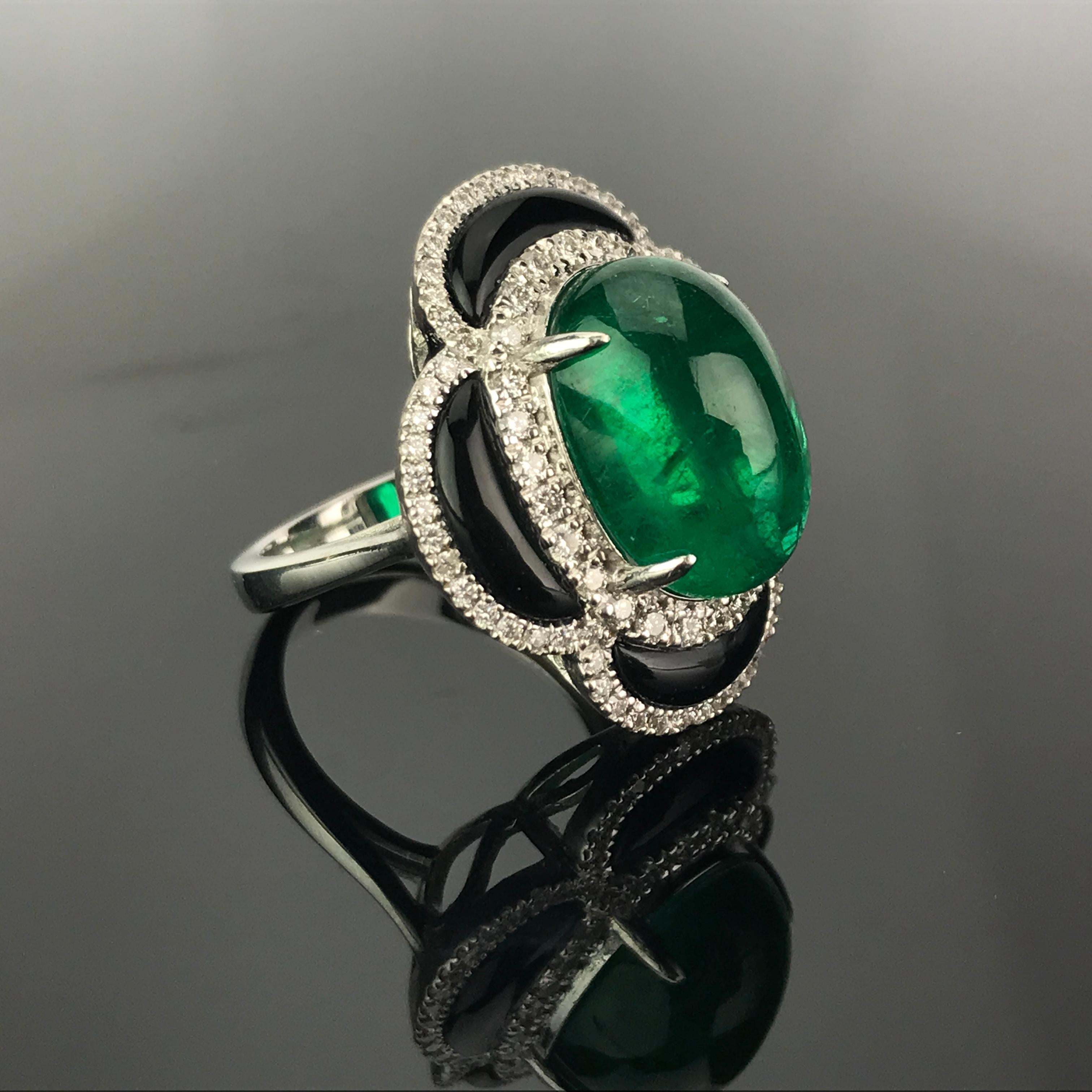 A stunning art-deco looking 9.40 carat lustrous Zambian Emerald cabochon with Black Onyx and Diamonds, set in 18K White Gold. Currently sized at US 6, can be resized without additional cost. Certificate can be provided upon request. 

Material