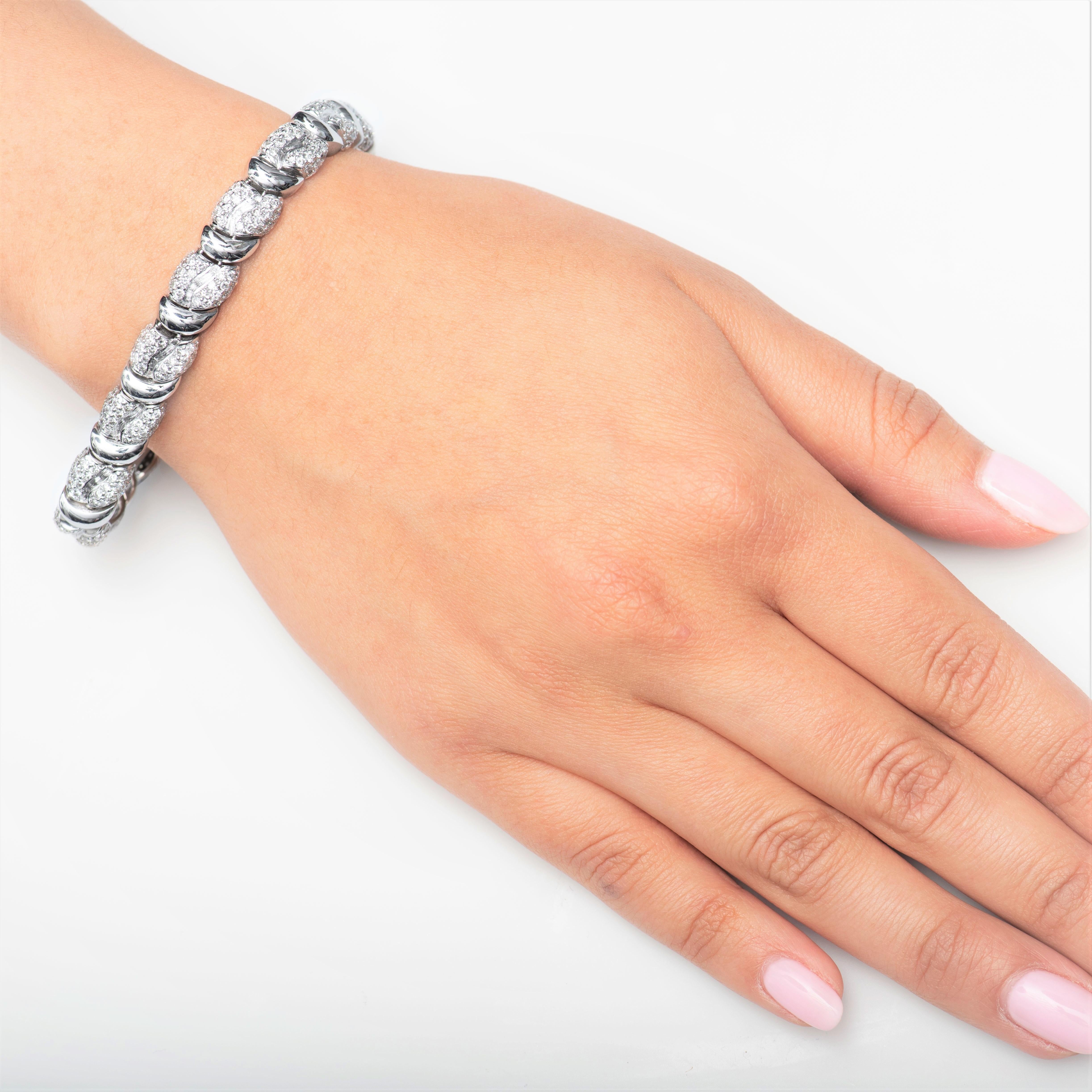 Estate 18K white gold bracelet with approximately 9.40 carats total in fine round white diamonds. The bracelet measures and fits a wrist size of 7 inches. The bracelet is beautifully crafted and makes a great addition to an everyday wear or to any