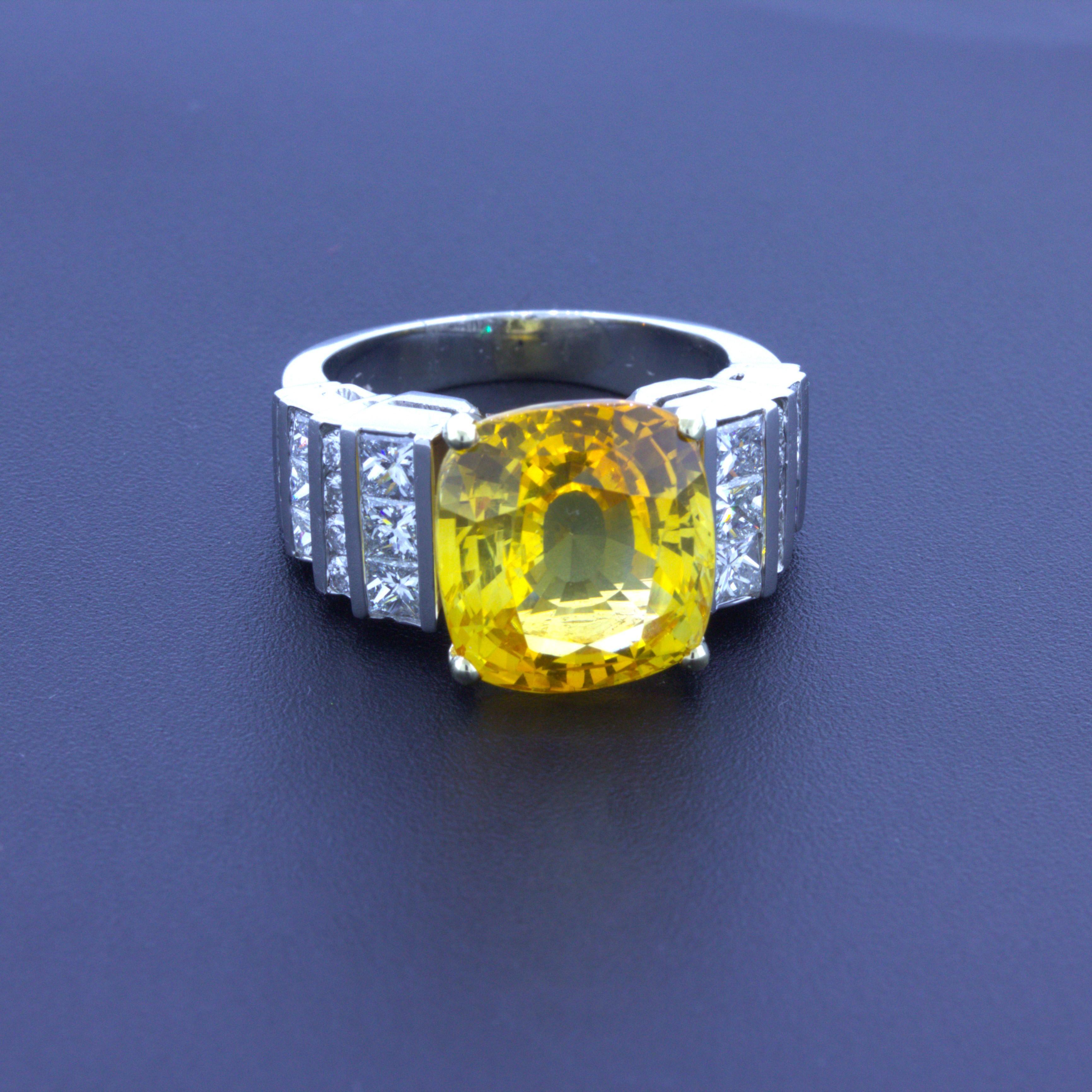 A chic and elegant diamond gemstone ring featuring a fine and natural yellow sapphire weighing 9.41 carats. The cushion-shape gem has a bright and brilliant orangy-yellow color that scintillates in the light. It is complemented by approximately 2