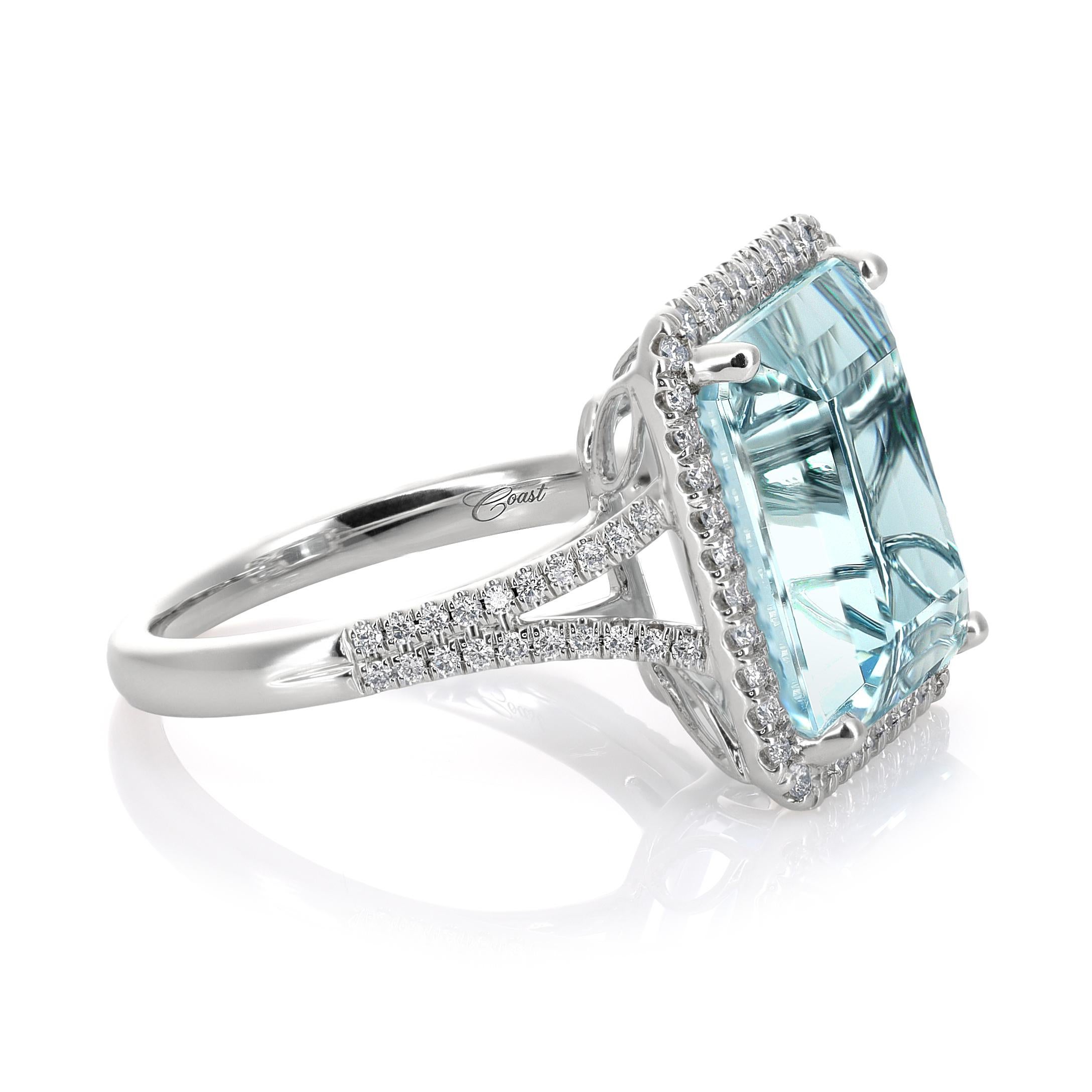 This stunning 14KW gold ring showcases a natural aquamarine gemstone, princess cut and weighing 9.45 carats. The aquamarine has undergone a heating process to enhance its color. The ring setting also includes 0.38 carats of diamonds, adding a touch