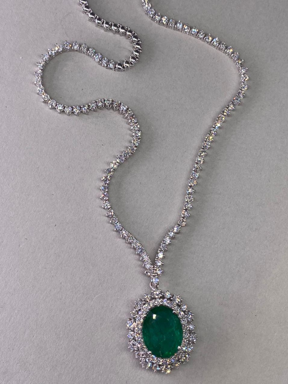 9.45 CTW Emerald 18K White Gold Diamond Necklace

Stamped: 750
Total Necklace Weight: 15.5 Grams
Necklace Length: 16 Inches
Emerald Weight: 5.25 Carat (12.701x10.00 Millimeters)
Diamond Weight: 4.20 Carat (F-G Color, VS2-SI1 Clarity)
Face Measures: