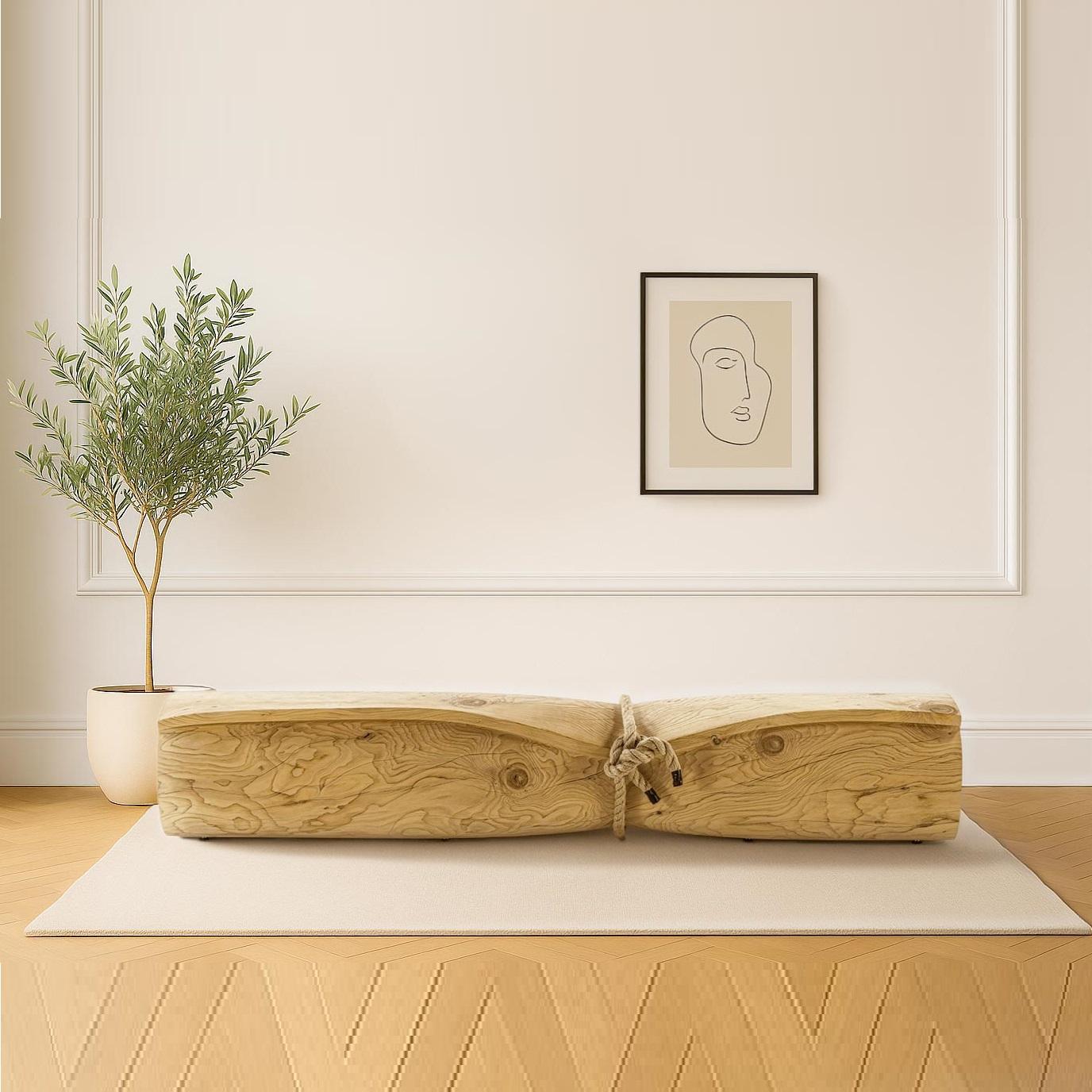 Ce banc est fabriqué d'une main de maître à partir d'un seul bloc de cèdre massif parfumé, mettant en valeur à la fois la force et l'art. Sa forme sculpturale et fluide s'inspire d'une feuille de papier roulée, créant un jeu saisissant entre le
