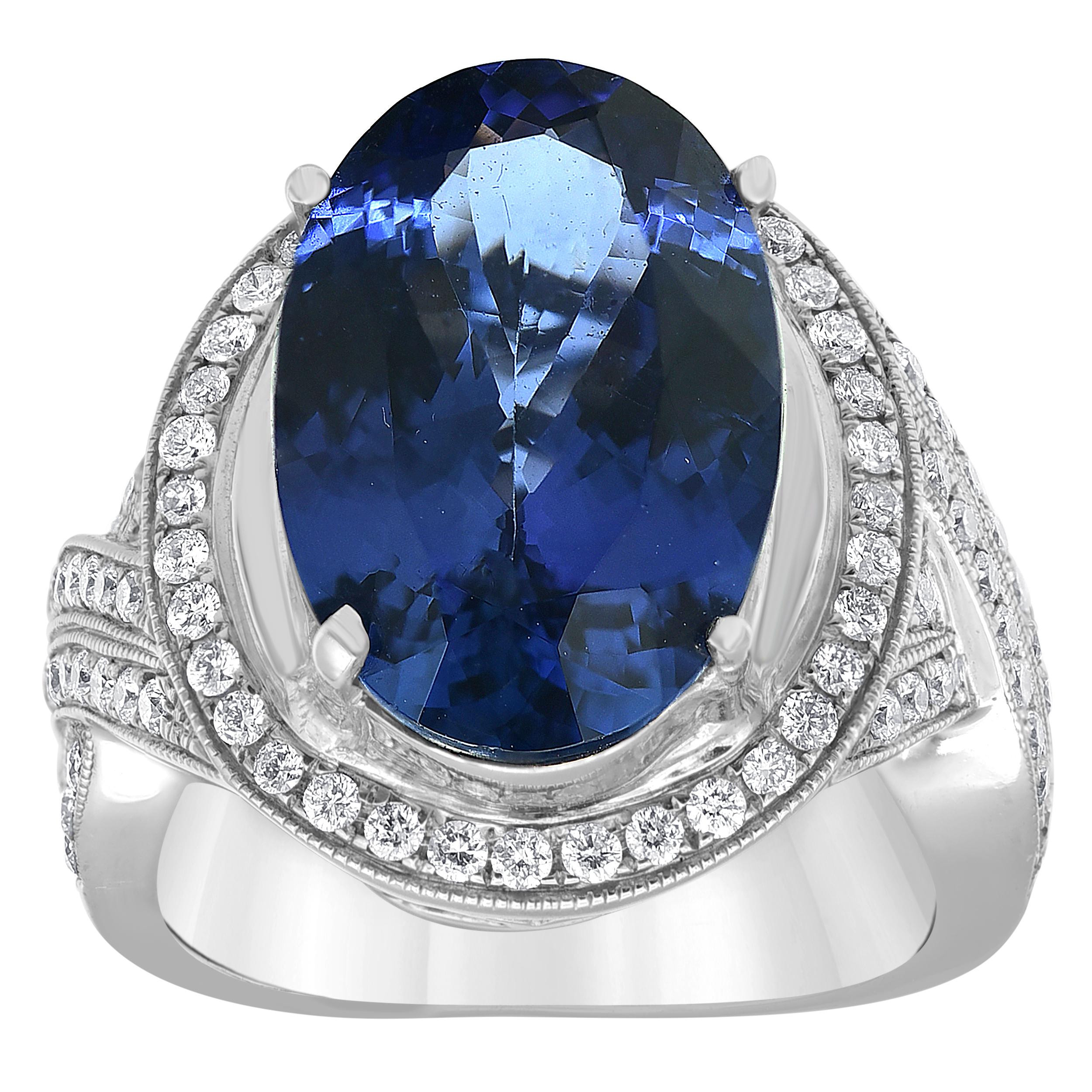 A vision of vivid colour, this tanzanite and diamond halo ring features a vibrant Blue oval tanzanite gemstone framed by a halo of prong set round brilliant diamonds set in polished 14k White gold.