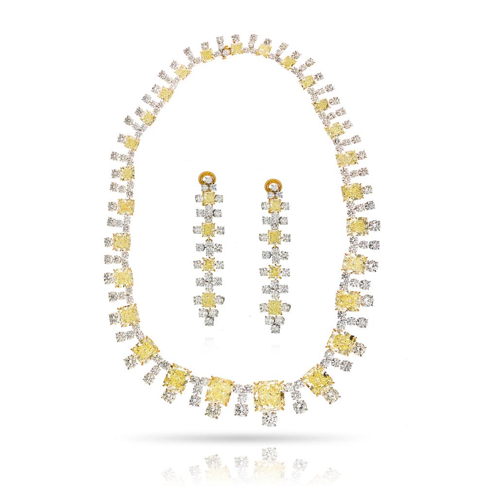 Dazzling fancy yellow diamond necklace and matching earrings featuring 27 GIA certified radiant-cut fancy yellow diamonds embraced by an additional 135 white round cut diamonds. 
Absolutely mind-blowing suite!

Red carpet-worthy this stunning