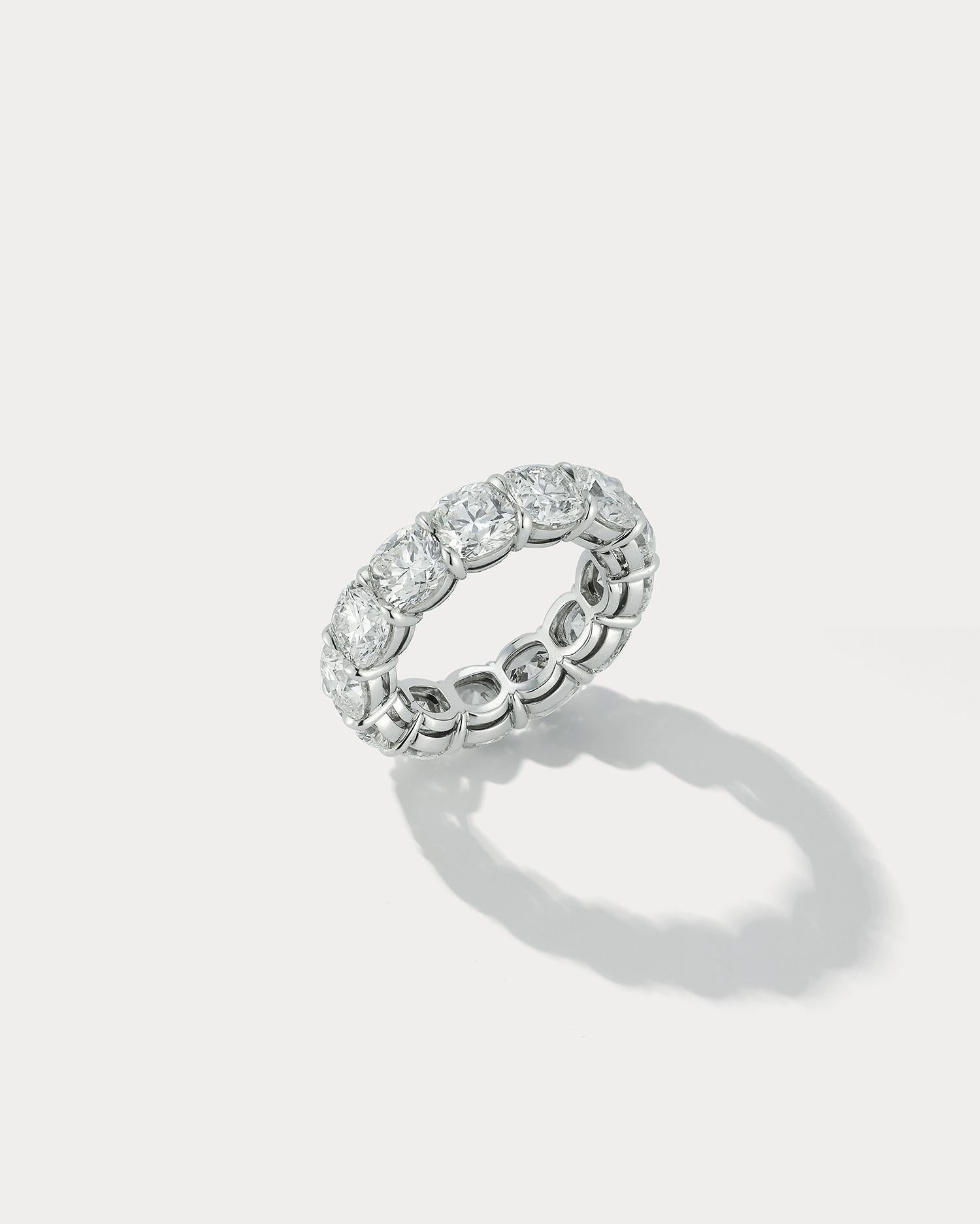 This magnificent 9.47 total carat Cushion Cut Wedding Band is the epitome of timeless elegance. Handmade by a skilled artisan, this ring is a unique and beautiful symbol of your love. The cushion cut stone, with its rounded edges and square or