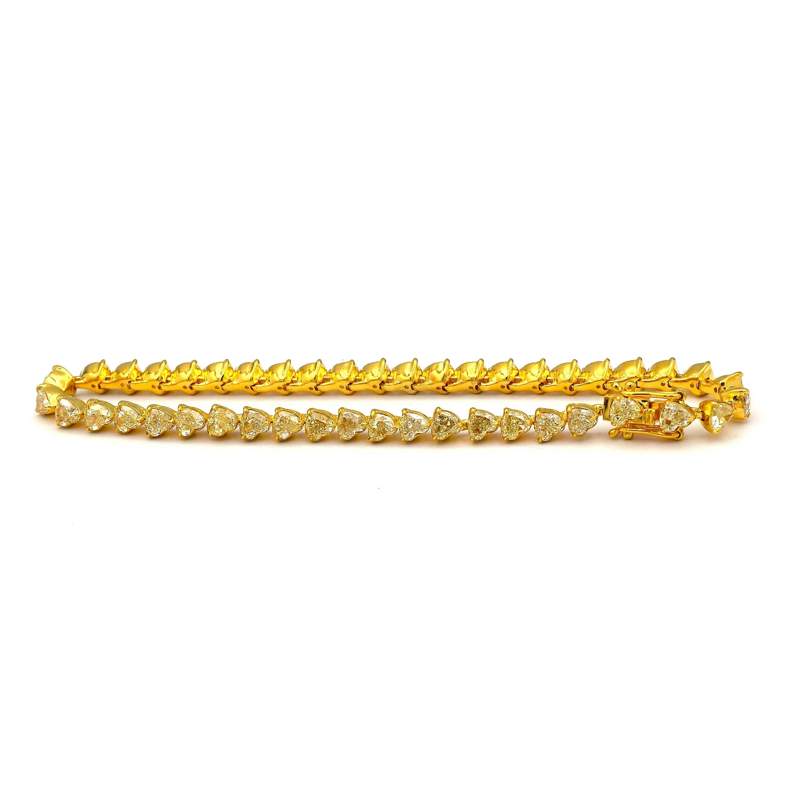 This simple and delicate Bracelet contains 44 Heart Shaped diamonds, giving it a total weight of 9.47ct. 

Mounted in 18K Yellow Gold, giving the bracelet a total weight of 10.76 grams. 