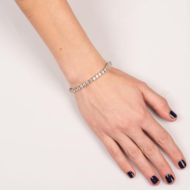 This tennis bracelet features 9.49 carat total weight on round brilliant cut diamonds set in 14 karat white gold. Box with double safety clasp. Wear this bracelet on its own or layer with other bracelets for a unique look. This bracelet is 7