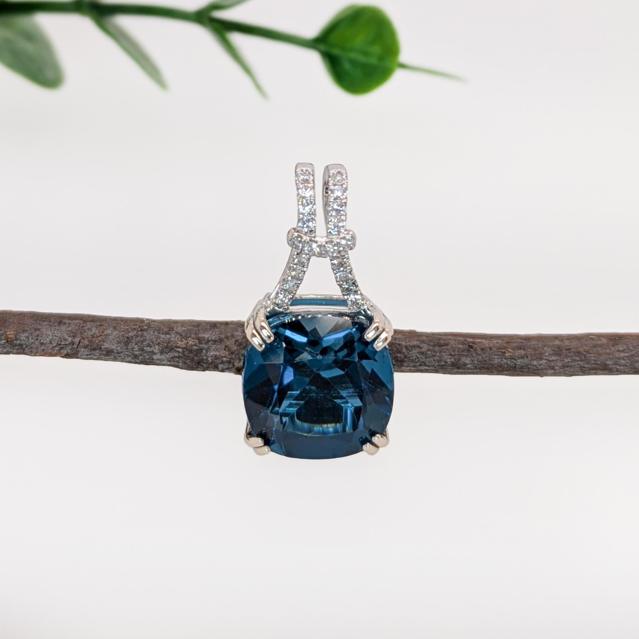 This beautiful pendant features a 9.39 carat London Topaz gemstone with natural earth mined diamonds. This pendant makes a stunning statement piece made in 14k gold that will elevate any outfit! This pendant also makes a lovely December birthstone