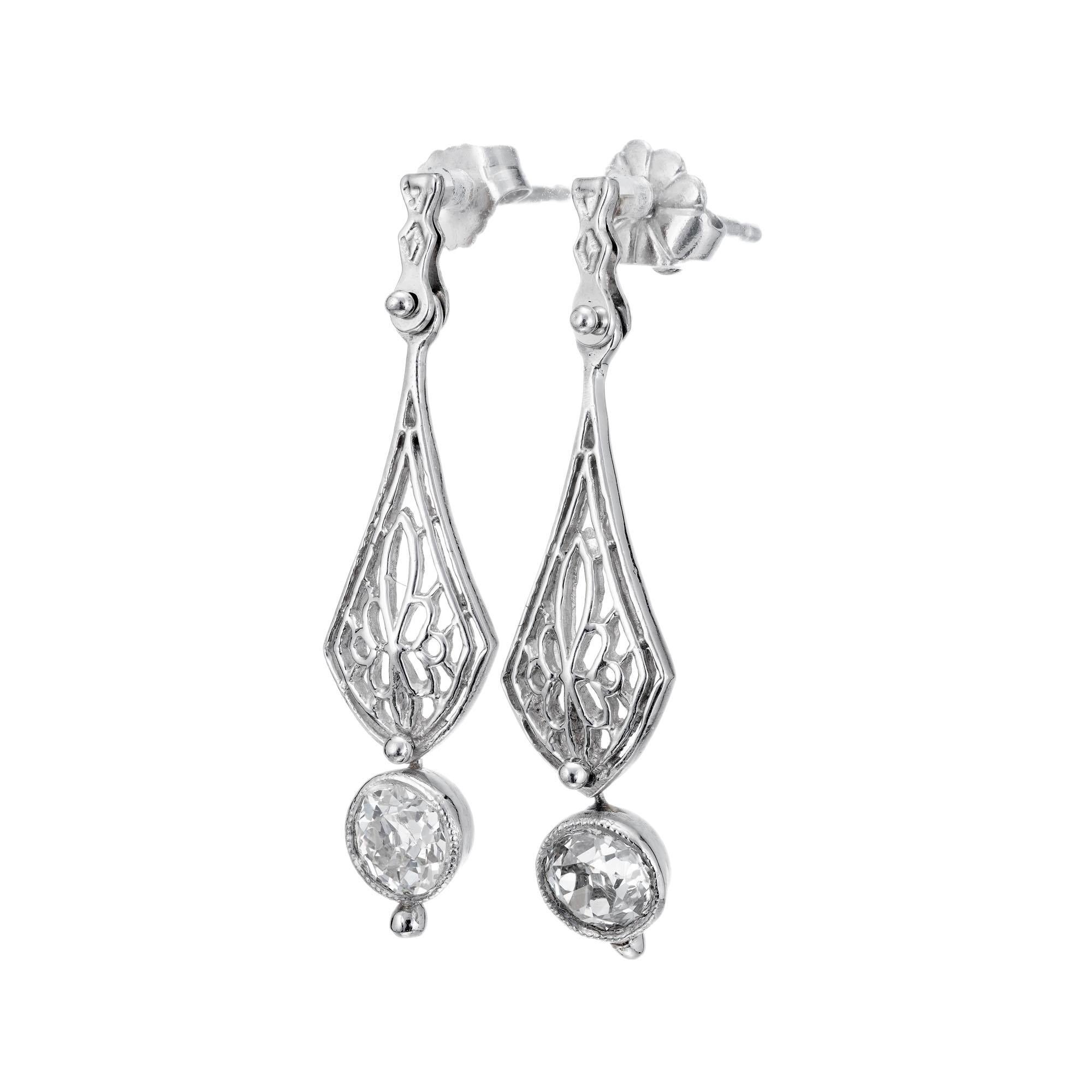 Edwardian style Platinum Art Deco handmade 1910-1920 diamond dangle earrings.  Tow old European cut diamonds dangle at the bottom center section.  Moves side to side on a rivet from the top section.  

2 old mine cut diamonds   approx.   total