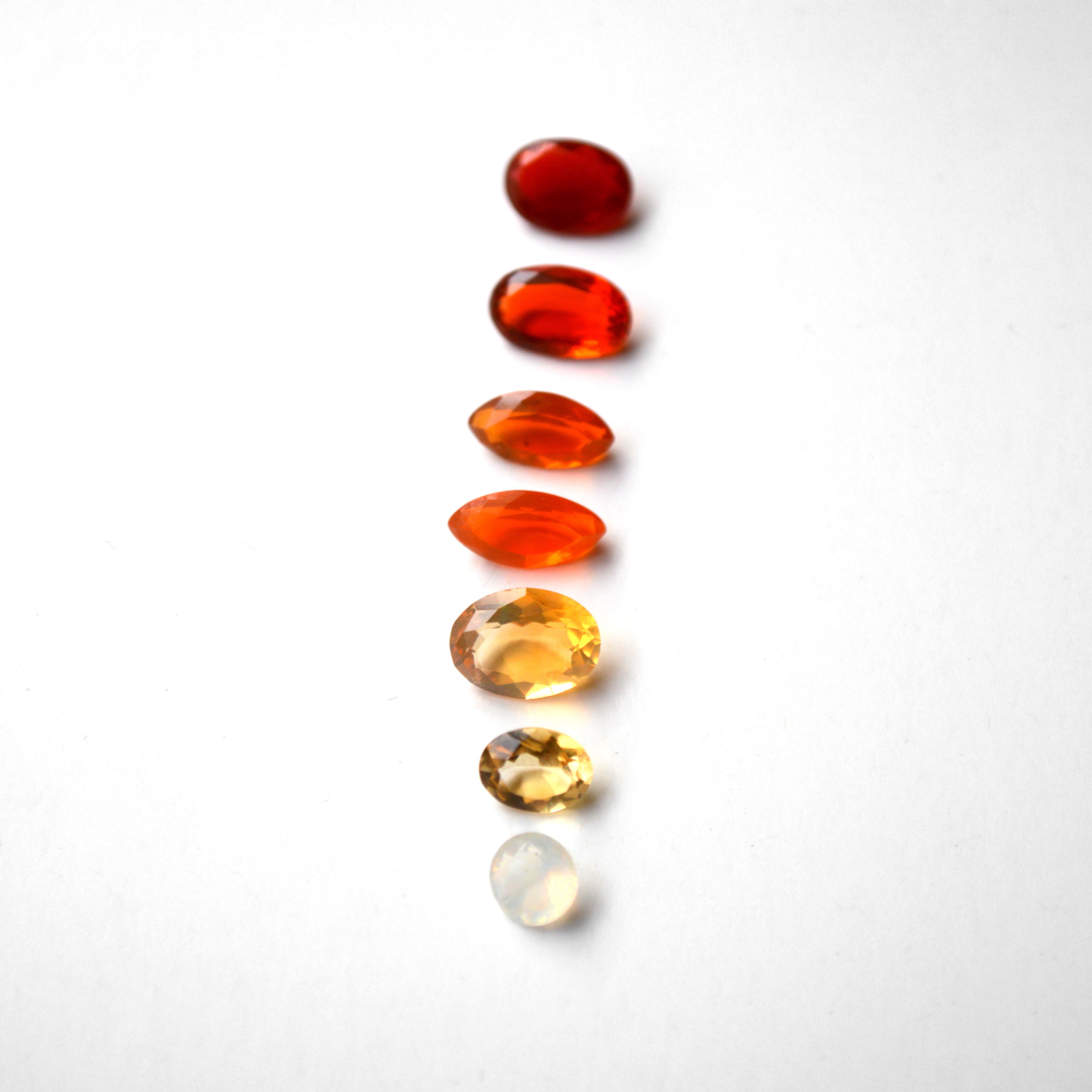 Lot of Loose Gemstones (7 pieces)
9.50 Carat in total 
Oval, marquise and brilliant cut stones
Fire Opal
Different colored opals, ranging from red, orange and yellow.

The biggest stone has the dimensions (yellow oval cut):
8.3 x 11 x 5.5 mm 
The