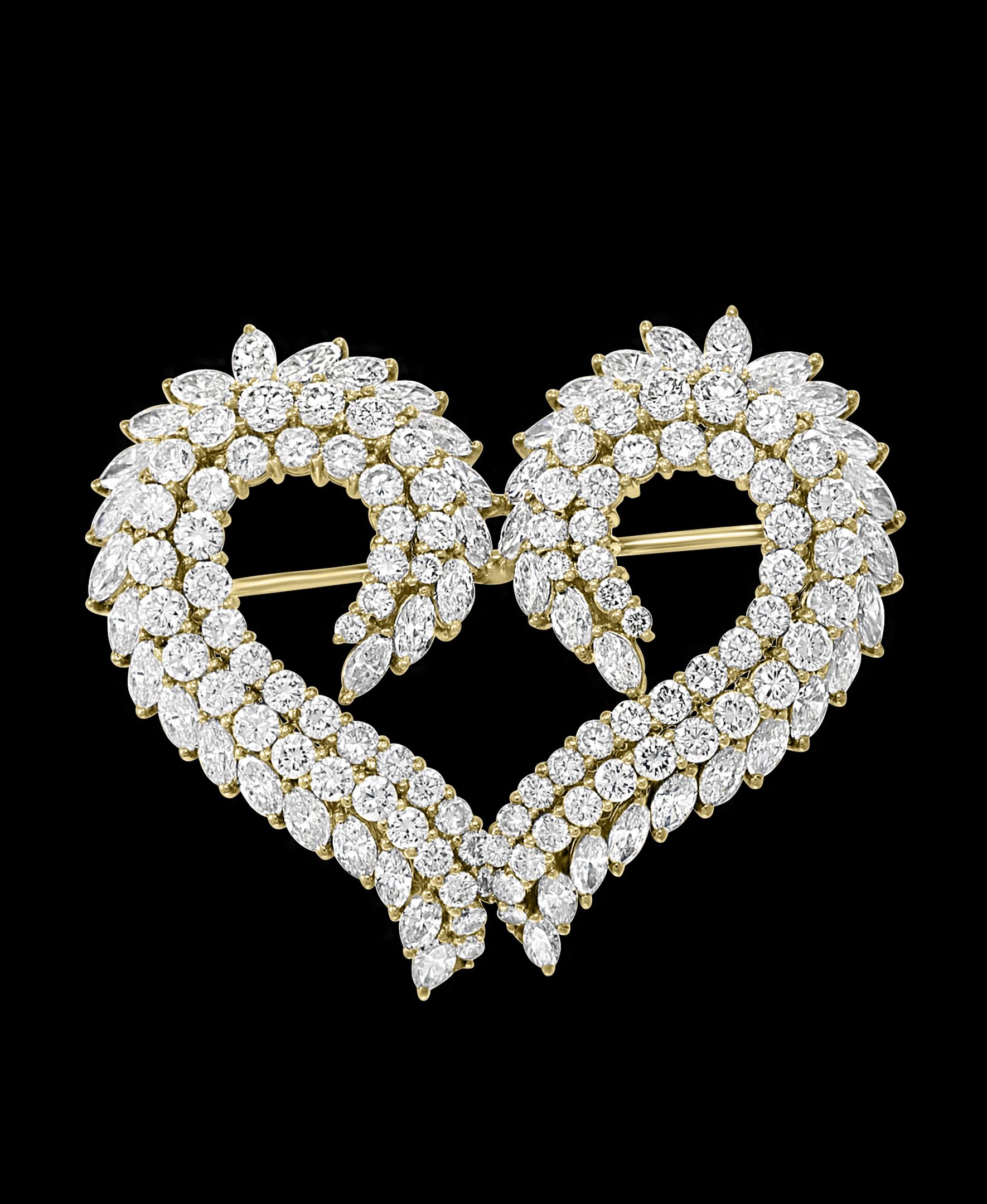  Antique Heart Shaped Diamond 18 Karat Gold Pin/Broach, VS Quality
Set with two rows of round diamonds and one row of Marquis diamond   in open back Prong settings with a combined approximate weight of 9.50 carats, to a gently curving heart shape