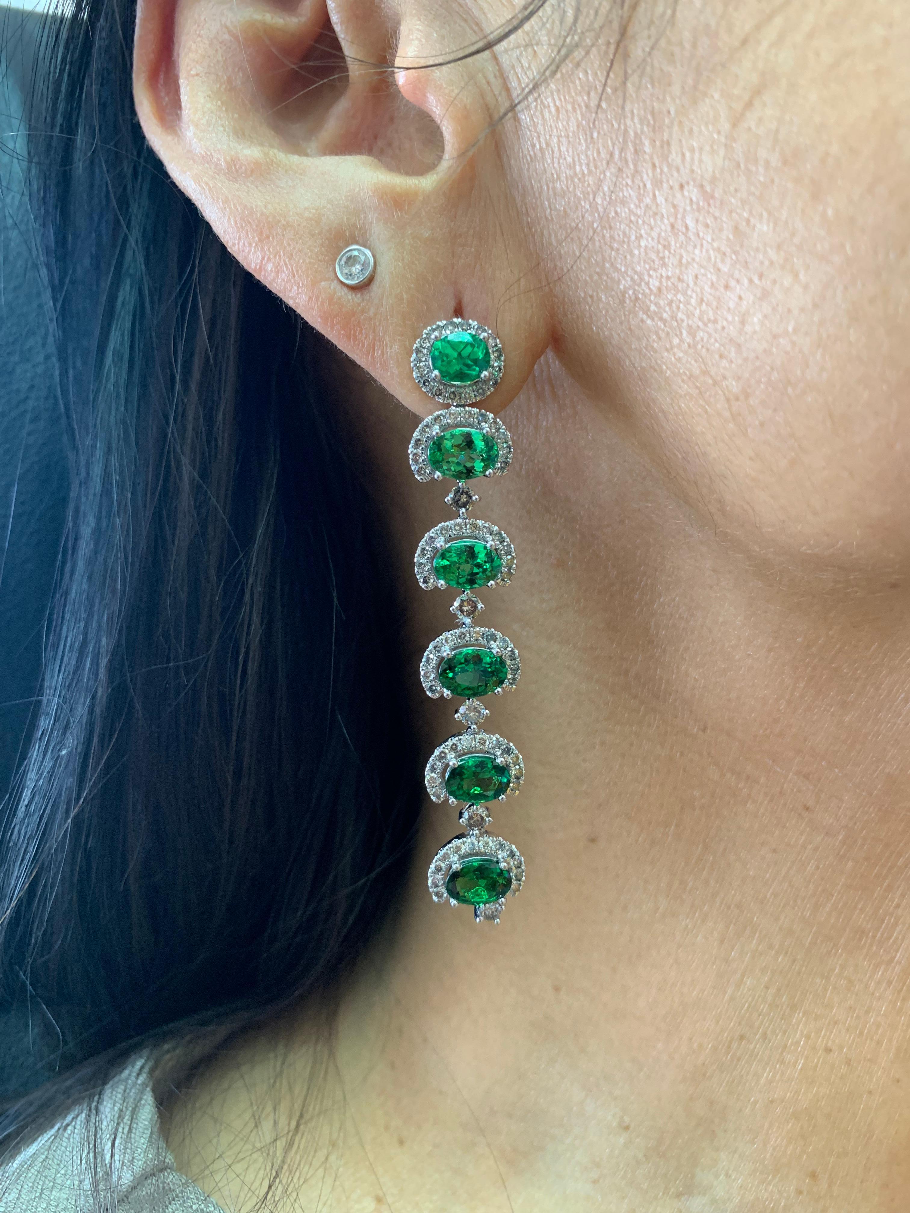 This is an elegant and simple tsavorite earring, set in a slight color gradient to accentuate the beauty of the gemstones. These dangle earrings are light and fun to wear, perfect for every occasion. 

Designer Tsavorite Earrings with Diamond in 18