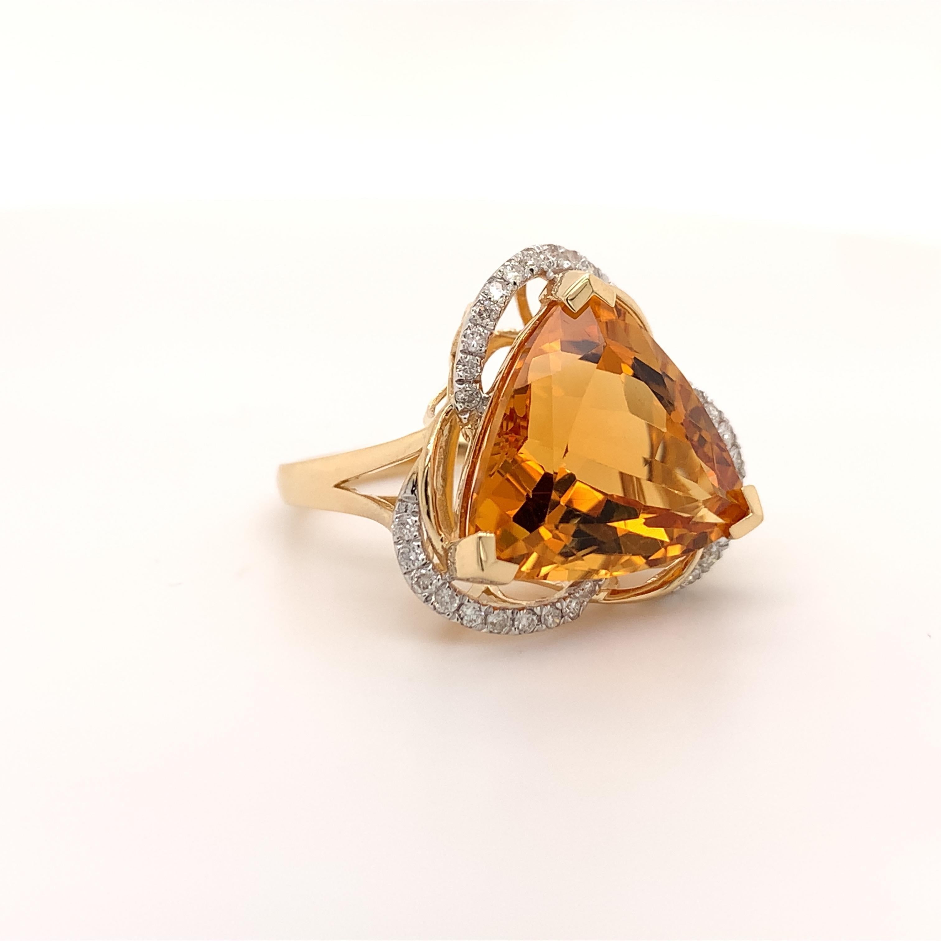 Stunning citrine cocktail ring. High brilliance, trillion cuts, transparent clean, rich golden honey tone 9.50 carats natural citrine mounted on high profile open basket with 3 knife prongs, accented with a round brilliant cut diamonds. Handcrafted