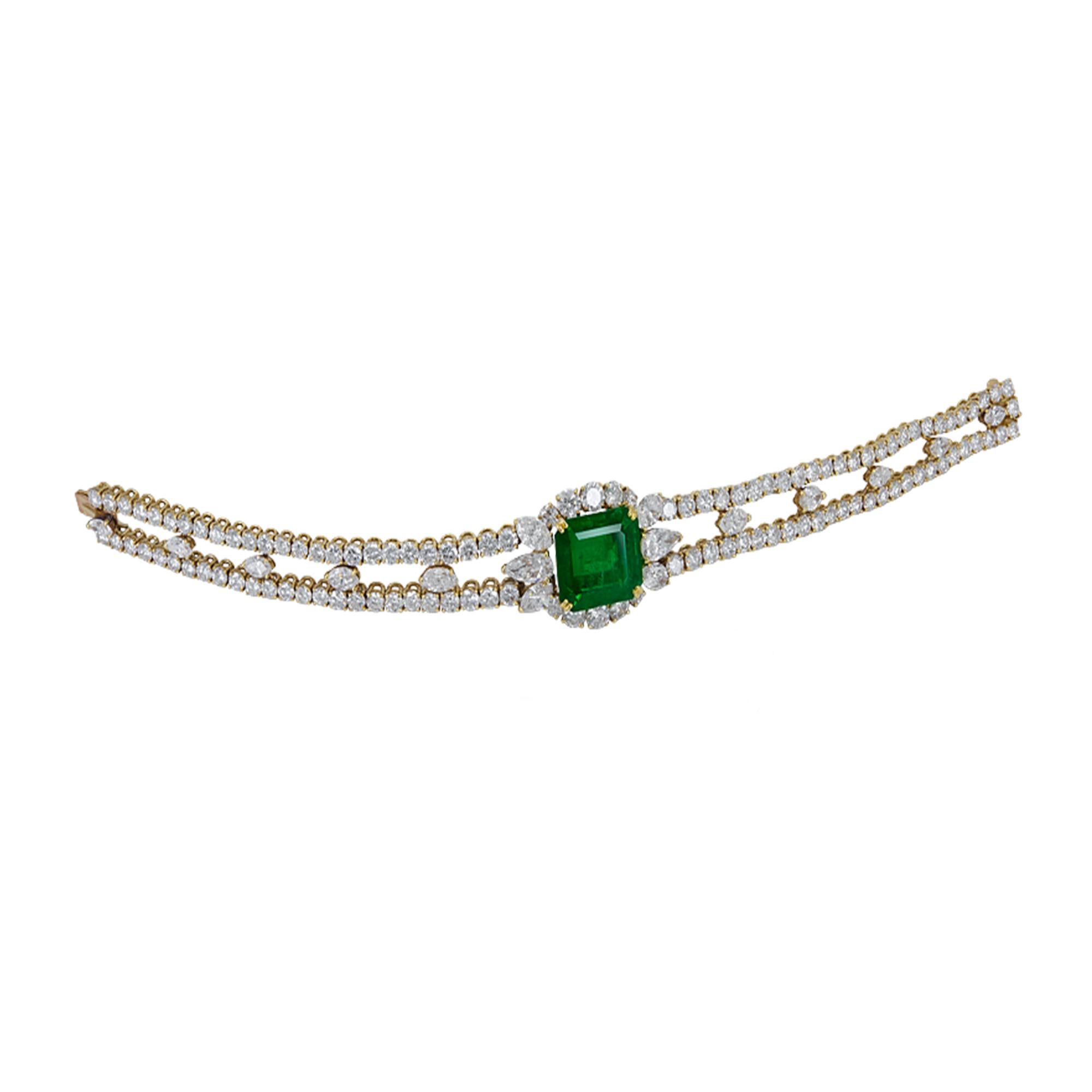 This amazing bracelet is embellished with a 9.50 carat Zambian emerald and 17.45 carats of white diamonds.
Accompanied by a certificate from SSEF.
Mounted in 18k yellow gold weighing 32.94 grams.
Created by the French jeweler Andre Vassort, one of