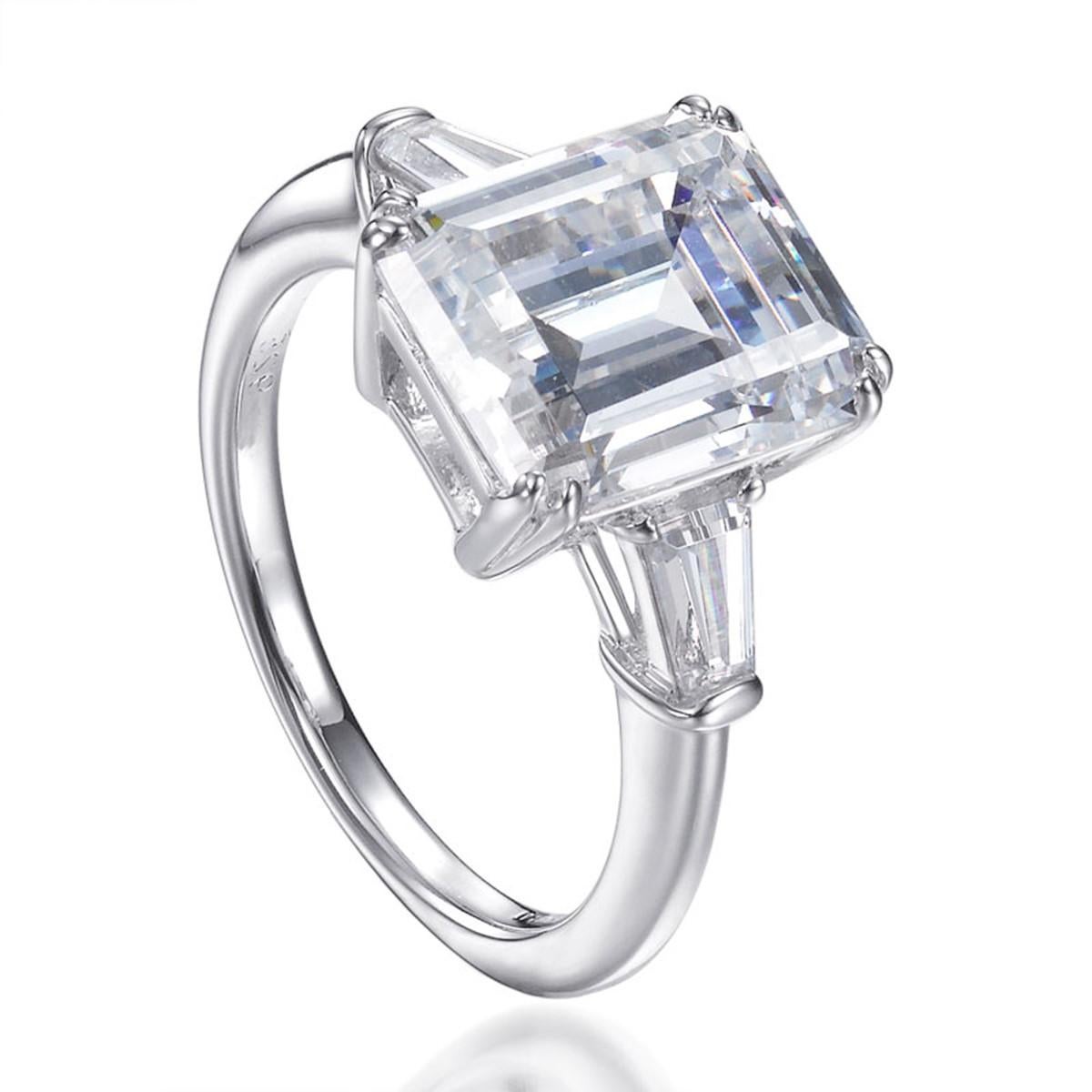 Part of our Deco Collection and inspired by the roaring twenties, this ring demonstrates a timeless elegance. 

Featuring an impressive 9.05 carat centre emerald cut cubic zirconia flanked by two tapered baguette cut cubic zironia. 

Composed of 925