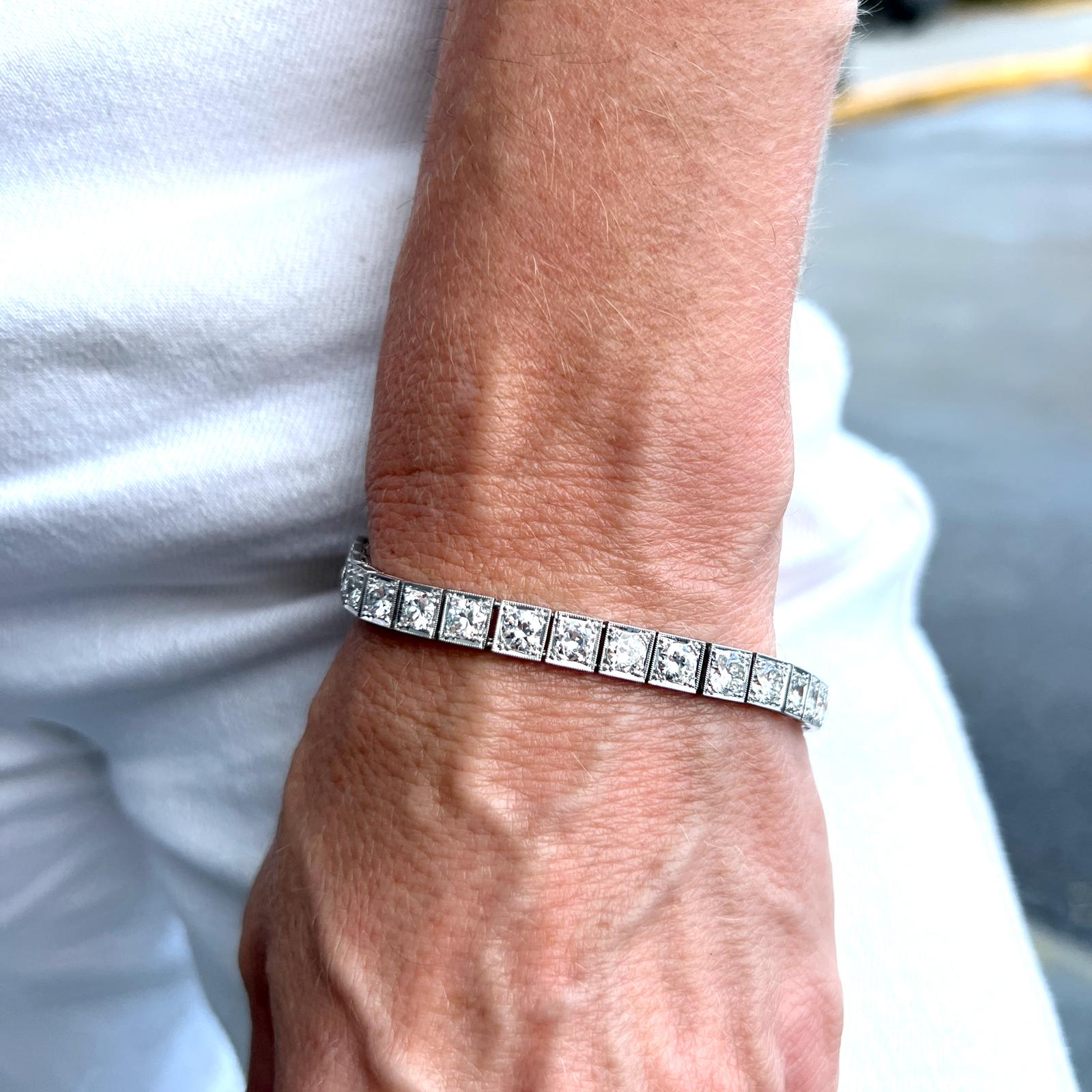 Timeless original diamond line bracelet crafted in platinum. The bracelet features 29 round brilliant cut diamonds weighing approximately 9.50 carat total weight (approximately .33 carat/diamond). The diamonds are graded G-H color and VS2-SI1