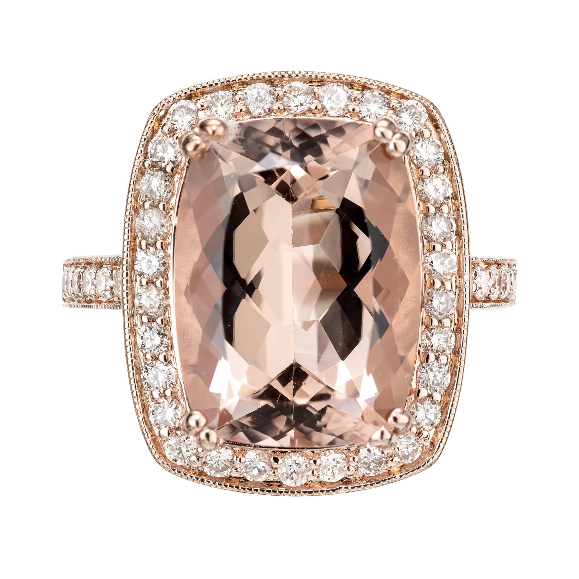 Stunning large pink morganite and diamond cocktail ring. This substantial cushion cut light pink morganite comes in at 9.50cts. Set in a 14k rose gold setting with halo of round cut diamonds along with accent diamonds on each side of the shank. 