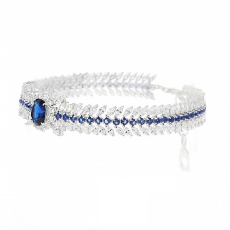  - Exclusive 950 Siledium silver
- Exclusive dual natural rhodium and palladium plating
- Set with exclusive Swan cut lab stones
- Hypoallergenic 
- Colour: white and blue glass
- Floral leaf band design with marquise cut
- Hypoallergenic 
-