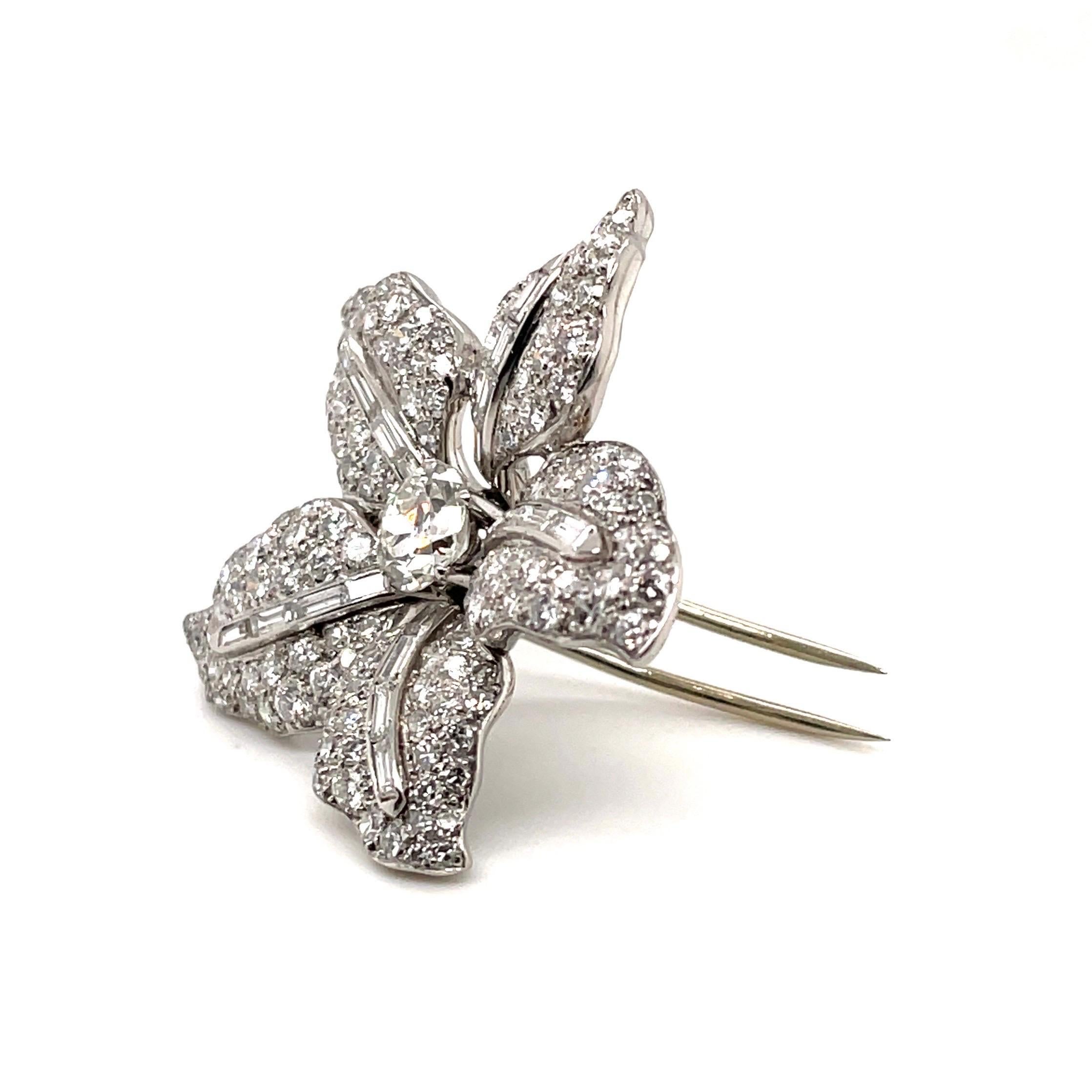 Elegant 950 platinum and diamond flower clip brooch, circa 1950. 

Classical, timeless clip brooch designed as a finely sculpted flower, centering upon one old-european-cut diamond of circa 0.9 carats, the leaves pavé-set with brilliant- and