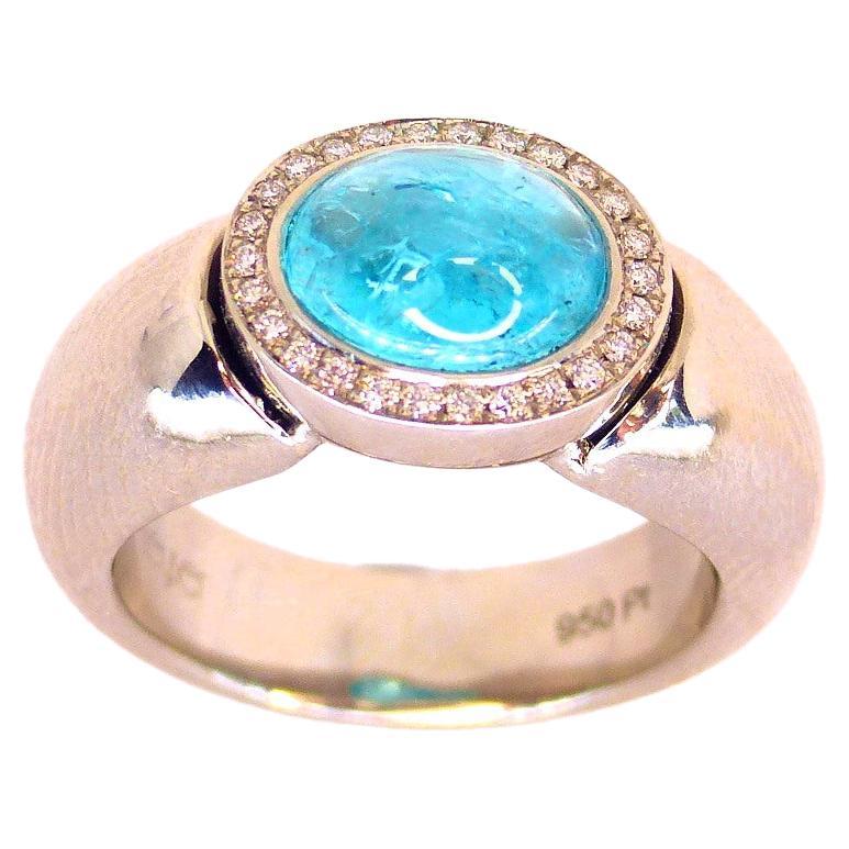 Ring in Platinum with 1 Paraiba Tourmaline Cabouchon Oval 9x7mm and 26 Diamonds 