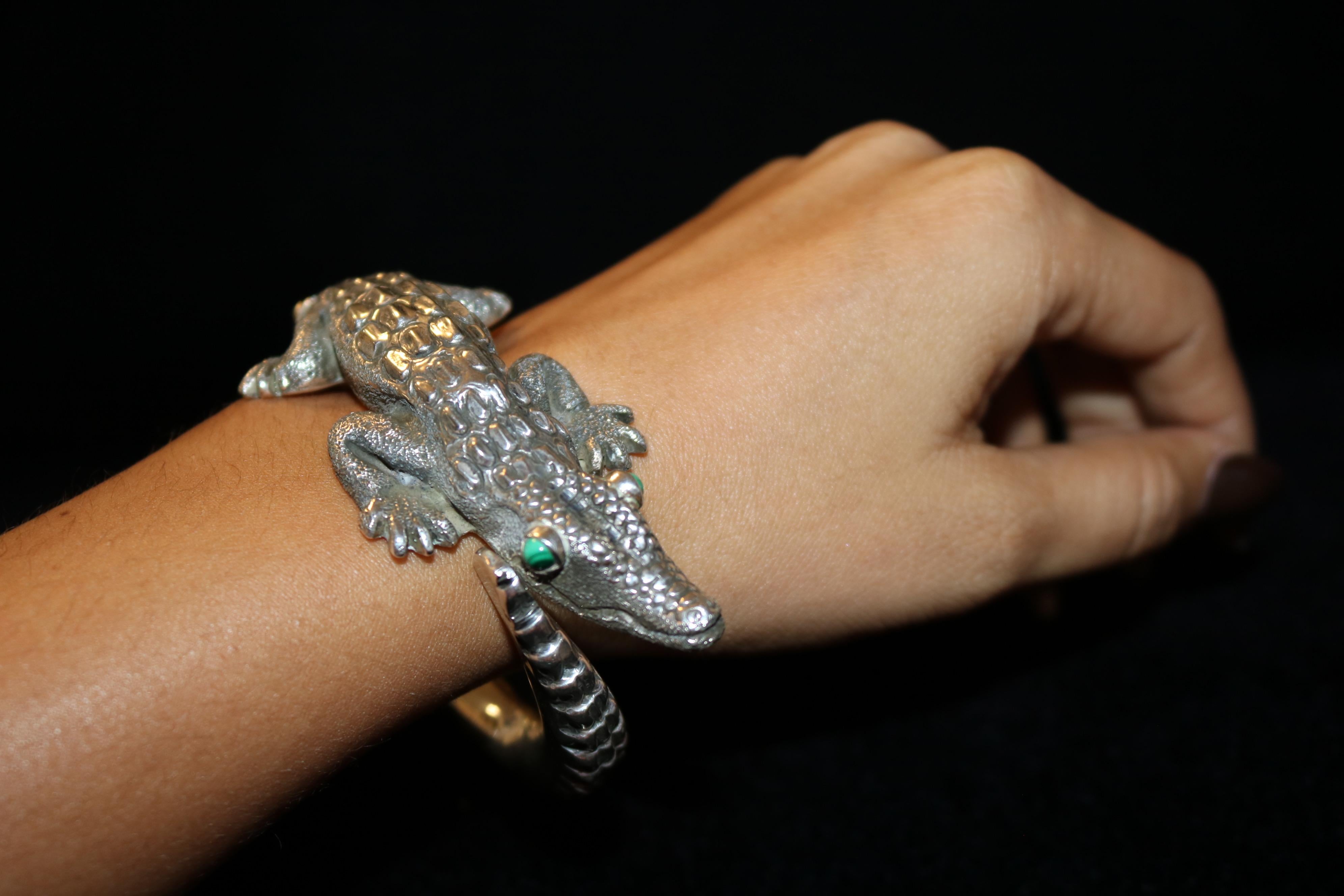 This beautiful 3D alligator design is definitely one of a kind piece. It was carefully handcrafted using the highest quality of 950 sterling silver. It's eyes are made of malachite stone which is said to bring harmony into one's life.
 This unique