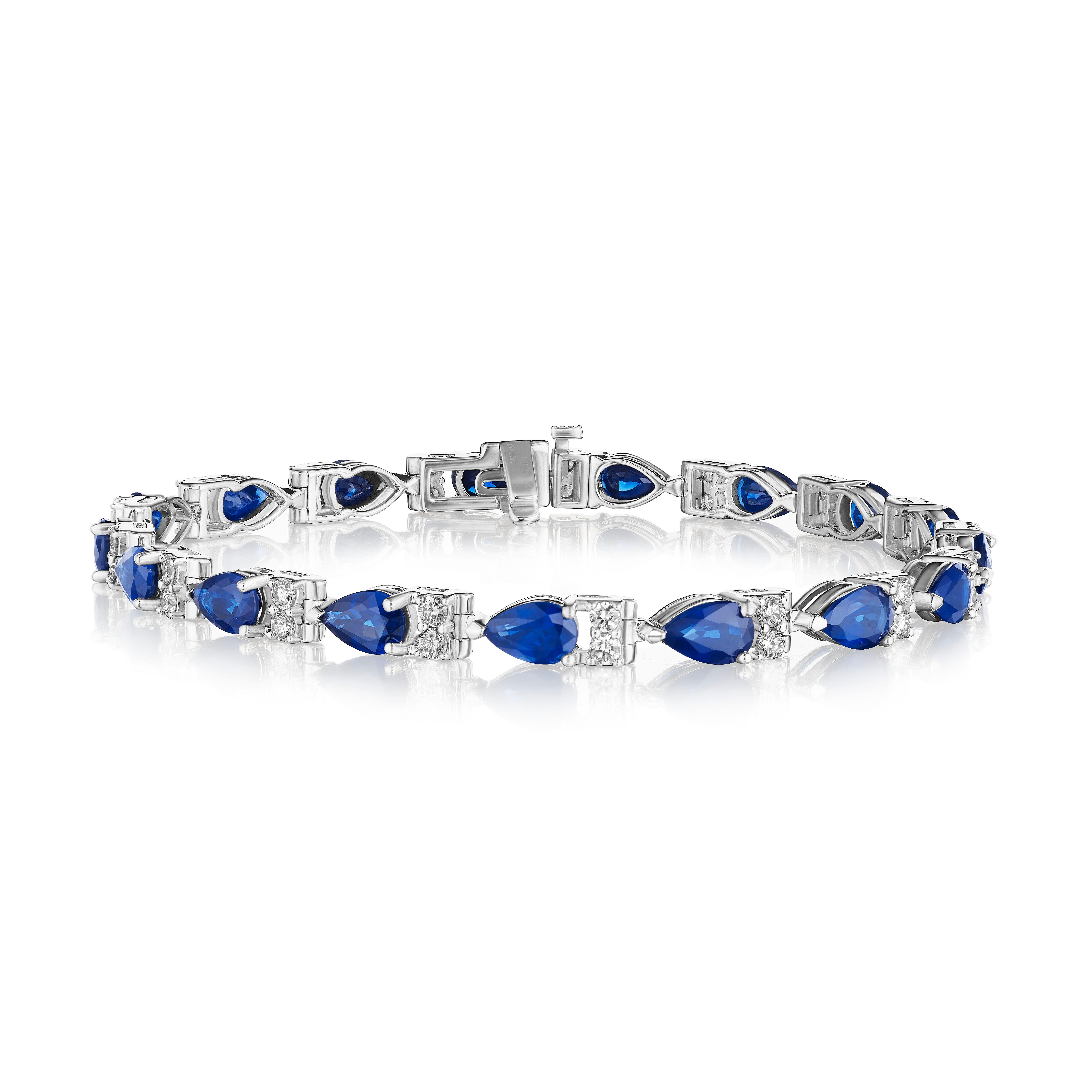 • A beautiful row of blue pear shape sapphires and white round brilliant cut diamonds encircle the wrist in this bracelet, set in 14KT gold. The bracelet measures 7