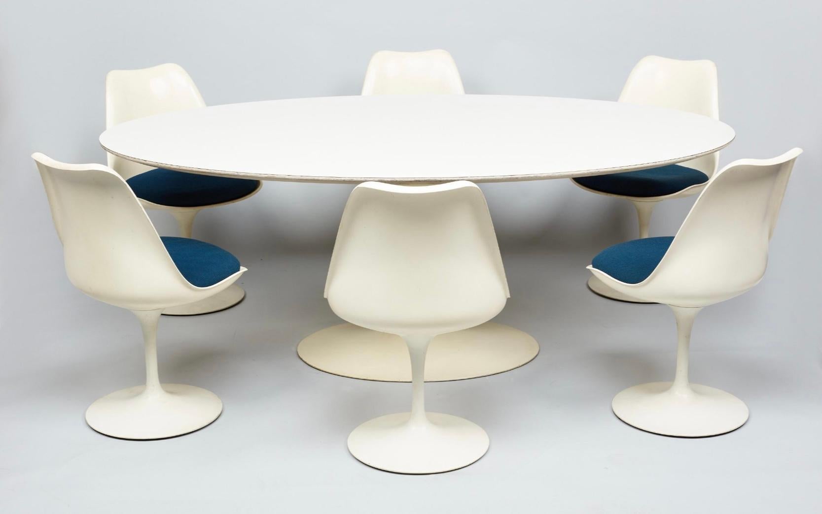 A rare complete late 1950’s Knoll Eero Saarinen Tulip Oval Tulip Table with six Saarinen matching chairs The Knoll label reads 575 Madison Ave. The fabric is original. Set in overall very good original condition. Retaining screws on the table are