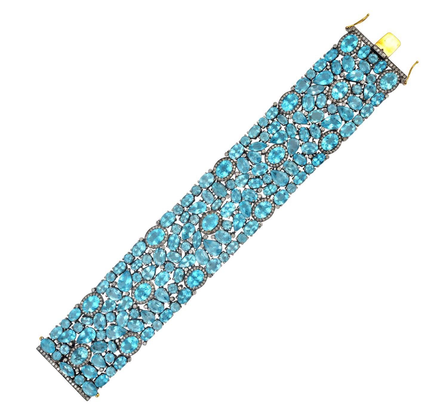 A stunning bracelet handmade in 18K gold and sterling silver. It is set in 95.1 carats  apatite and 2.95 carats diamonds. Pair this with your favorite evening dress for a red carpet look. Clasp Closure

FOLLOW  MEGHNA JEWELS storefront to view the
