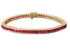 9.52 Carat Princess Cut Ruby Channel Set Tennis Bracelet in 18 Karat Yellow Gold