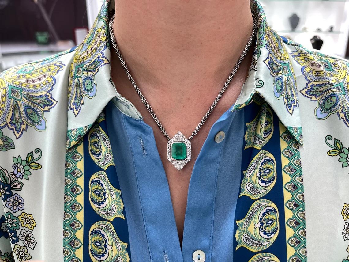 Enthrall in this majestic natural Colombian emerald necklace. The center stone features a remarkable 8.76-carat, natural Colombian emerald that showcases a vivacious medium green color with a minimal yellowish-green hue. The stone's size followed