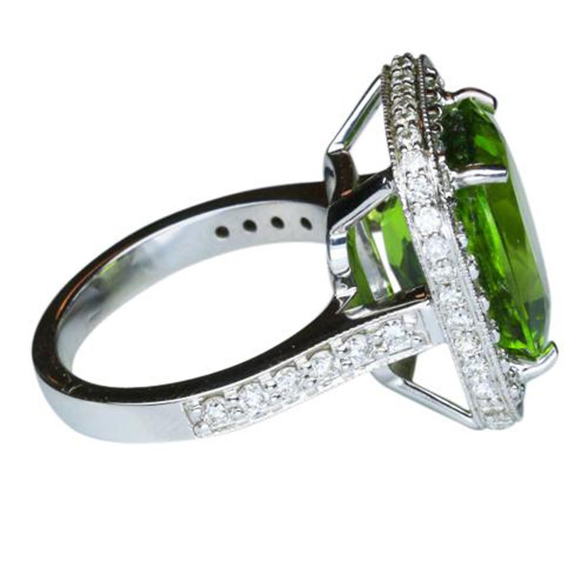 Elegant & finely detailed Ring, center set with a securely nestled 11.29 Cushion Cut Green Peridot, 14.0mm x 11.5mm; clarity internally flawless (IF), no treatment; surrounded by and enhanced on shank with micro-set Brilliant full cut Diamonds,