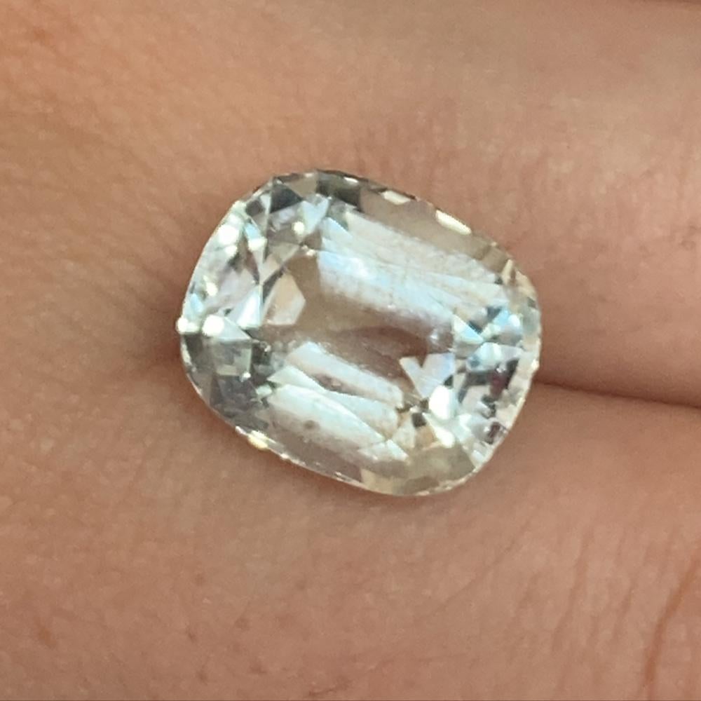 Description:

Gem Type: Aquamarine 
Number of Stones: 1
Weight: 9.54 cts
Measurements: 13.90 x 11.59 x 9.17 mm
Shape: Cushion
Cutting Style Crown: Brilliant Cut
Cutting Style Pavilion: Step Cut 
Transparency: None
Clarity: Very Slightly Included: