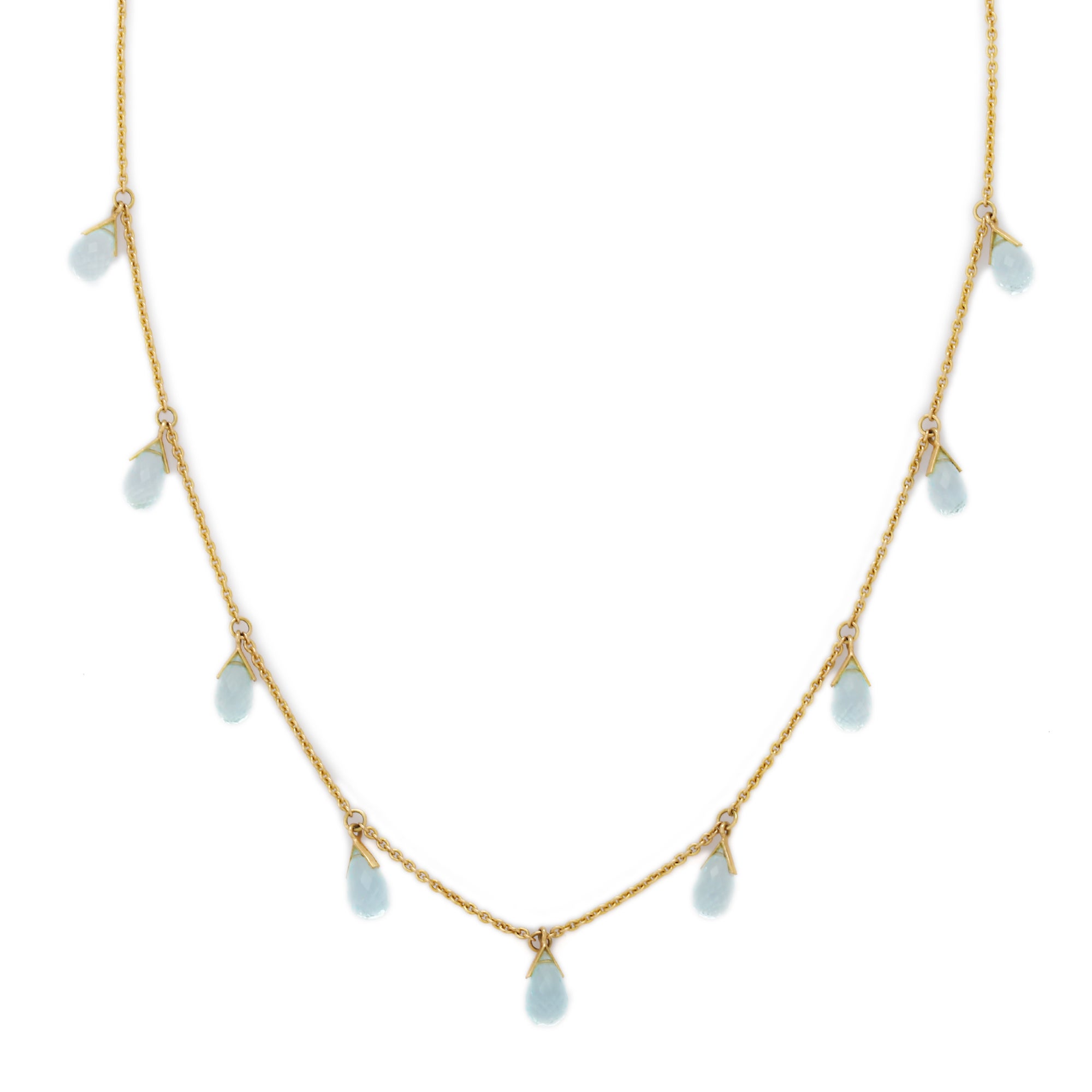 Blue Topaz Necklace in 18K Gold studded with drop cut topaz.
Accessorize your look with this elegant blue topaz charm necklace. This stunning piece of jewelry instantly elevates a casual look or dressy outfit. Comfortable and easy to wear, it is