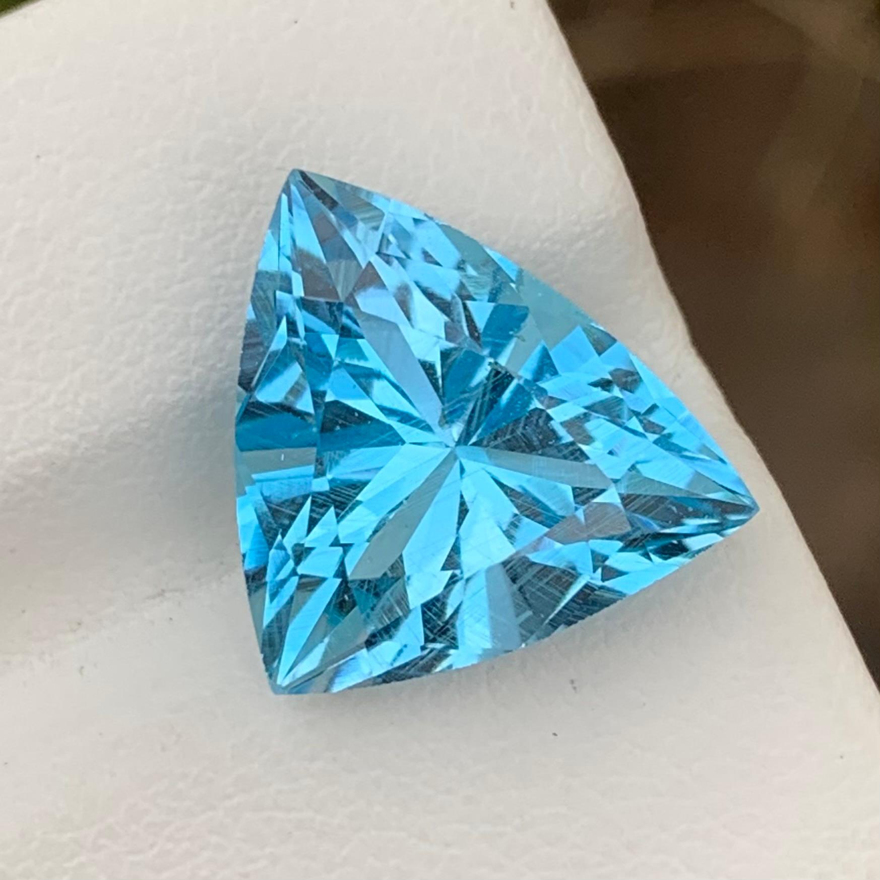 Loose Blue Topaz 
Weight: 9.55 Carats
Dimension: 13.1 x 13.1 x 8.8 Mm 
Origin: Brazil
Colour: Blue
Certificate: On Demand
Shape: Triangle 

Blue topaz is a stunning gemstone prized for its vibrant blue color and remarkable clarity. It belongs to the