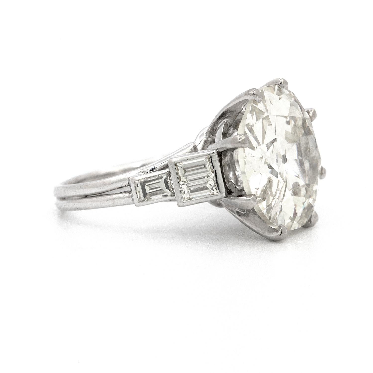 A custom made 8 prong platinum ring featuring a 9.58 carat Old European Cut diamond with a slightly eye visible inclusion on the side. Beautifully accented with 6 straight baguette shaped diamonds that weigh 0.60 carats.    Complimentary sizing     
