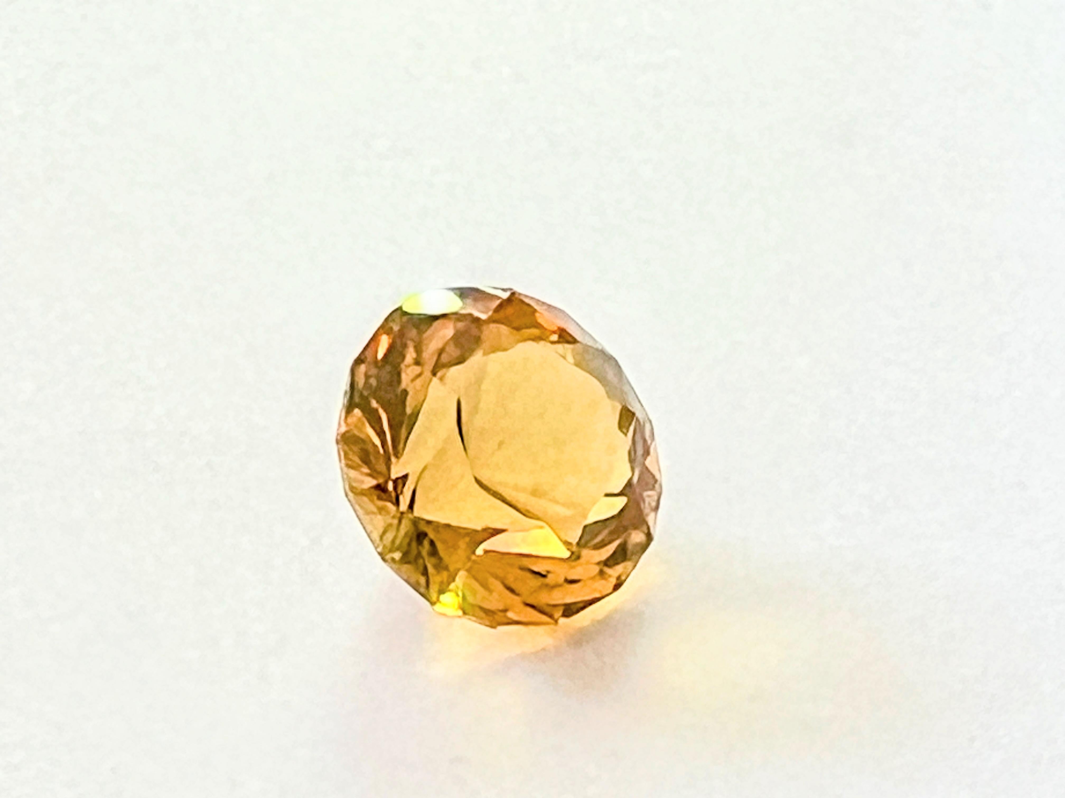 Introducing our loupe clean natural 9.5ct Round Cut Yellow Citrine—a gemstone that captures the warmth and radiance of the sun itself. This exquisite citrine, with its brilliant yellow hue, is presented in a classic round cut, allowing its natural