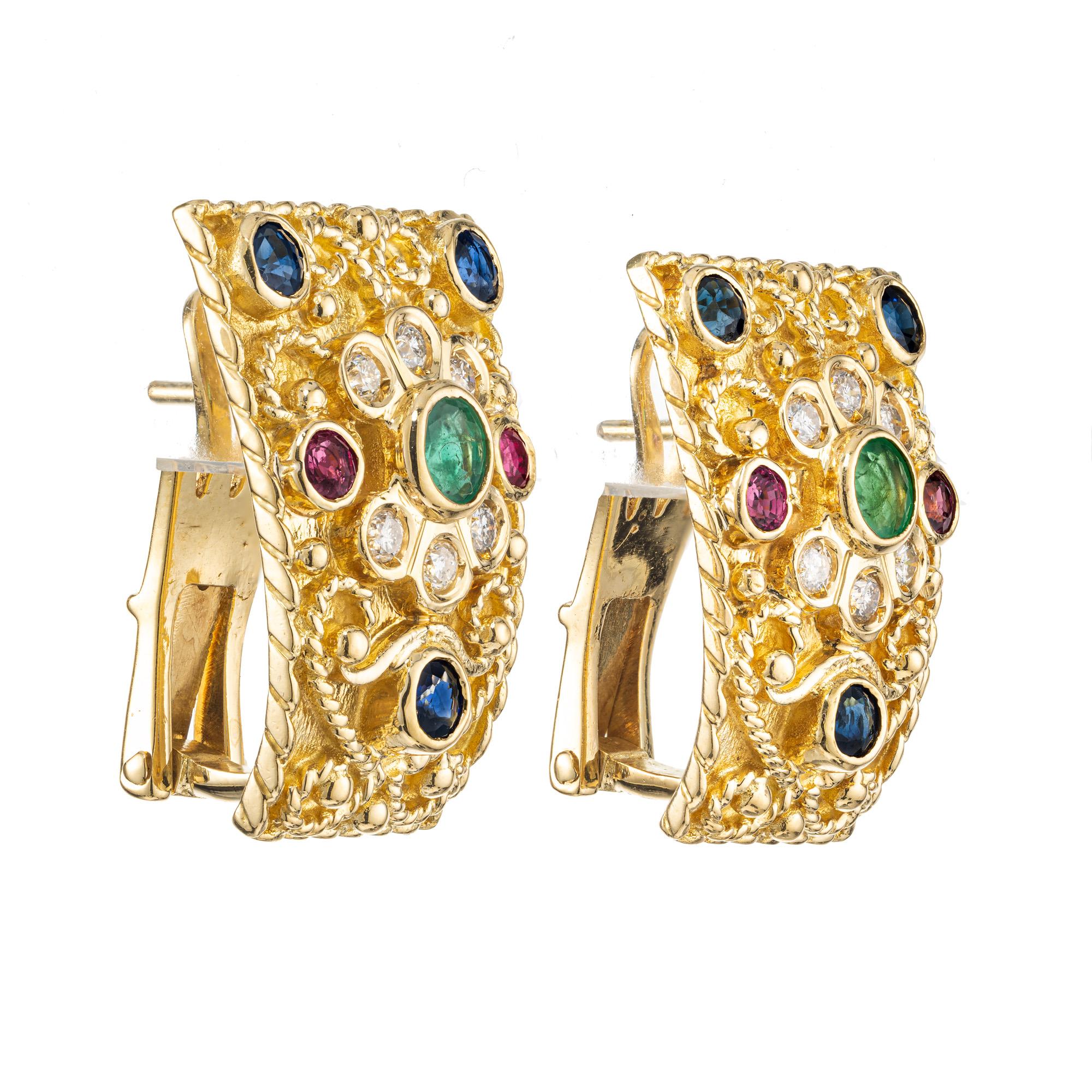 Byzantine style multi stone gemstone earrings. Handmade beautifully textured and highly detailed, these 18k yellow gold clip post earrings are adorned with two round emeralds, 6 round sapphires, 4 round rubies, 2 round emeralds and 12 round