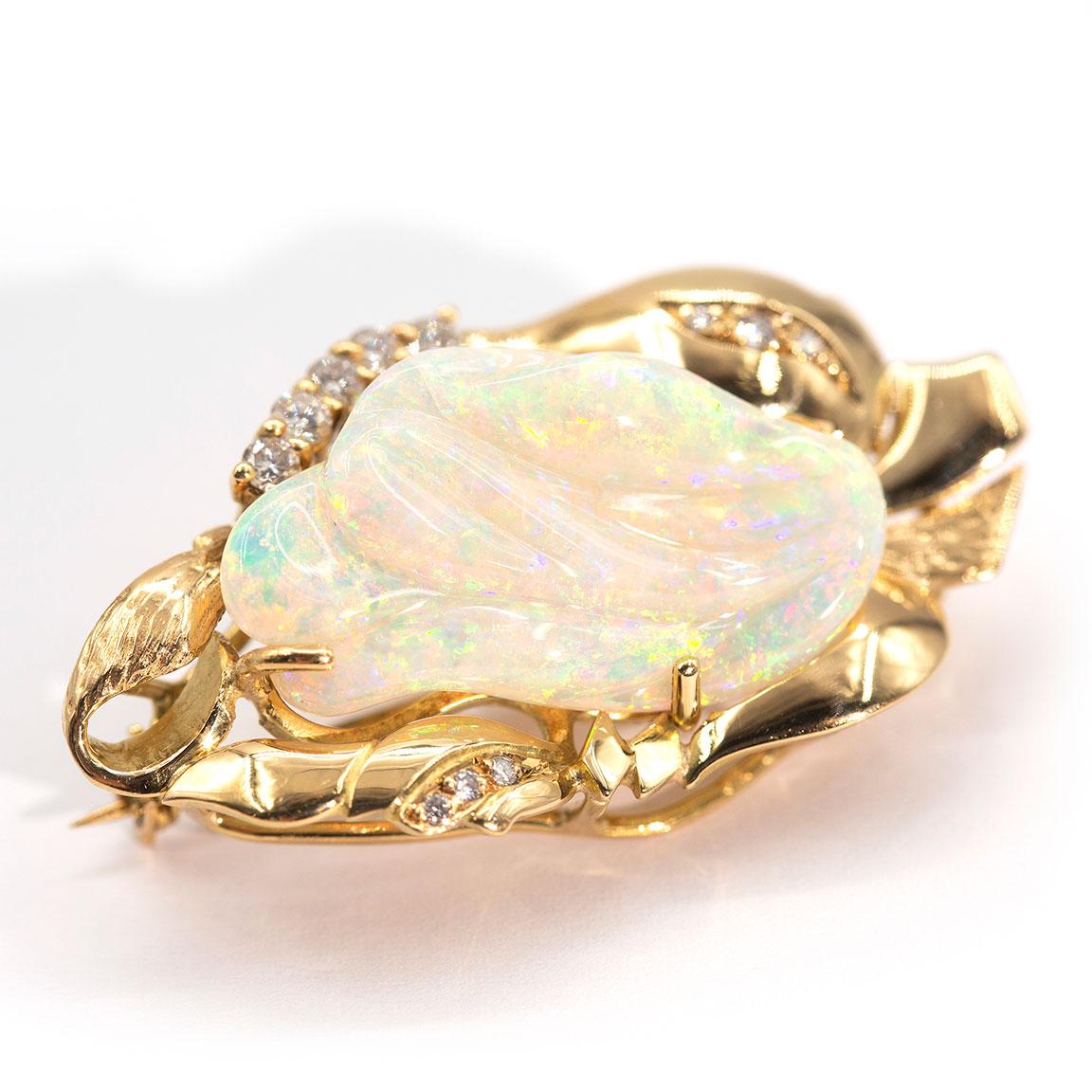 Lovingly crafted in 18 carat yellow gold is this enchanting vintage pendant with an alluring 9.6 carat solid carved Opal taking centre stage, and carefully set in a fine four claw setting.  She has an ornate free form border beset with sparkling