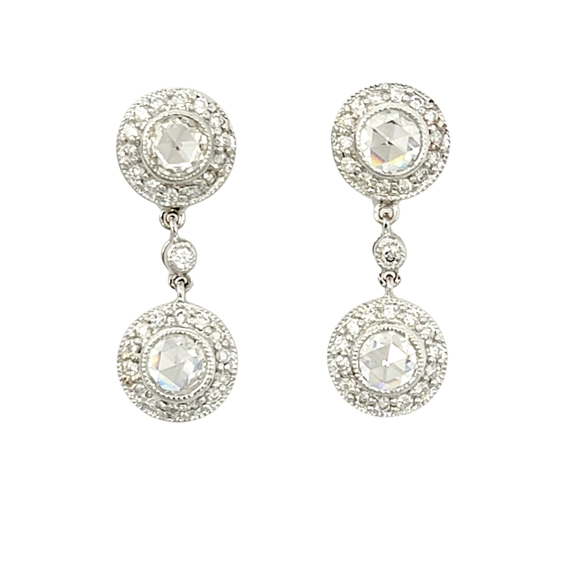 Gorgeous double diamond halo dangle earrings bursting with incredible sparkle.

Earring style: Dangle
Metal: 14 Karat White Gold 
Natural Diamonds: .96 ctw
Diamond color: G-H
Diamond clarity: VS2-SI1
Diamond cut: Rose and Round
Length: 1